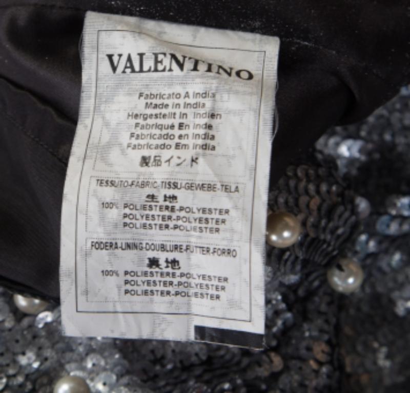 This beauty of a dress from Red Valentino comes especially tailored for you. It is designed as a sleeveless and embellished with sequins all over and on the neckline, there are decorations of faux pearls and beads. This sleeveless dress will look