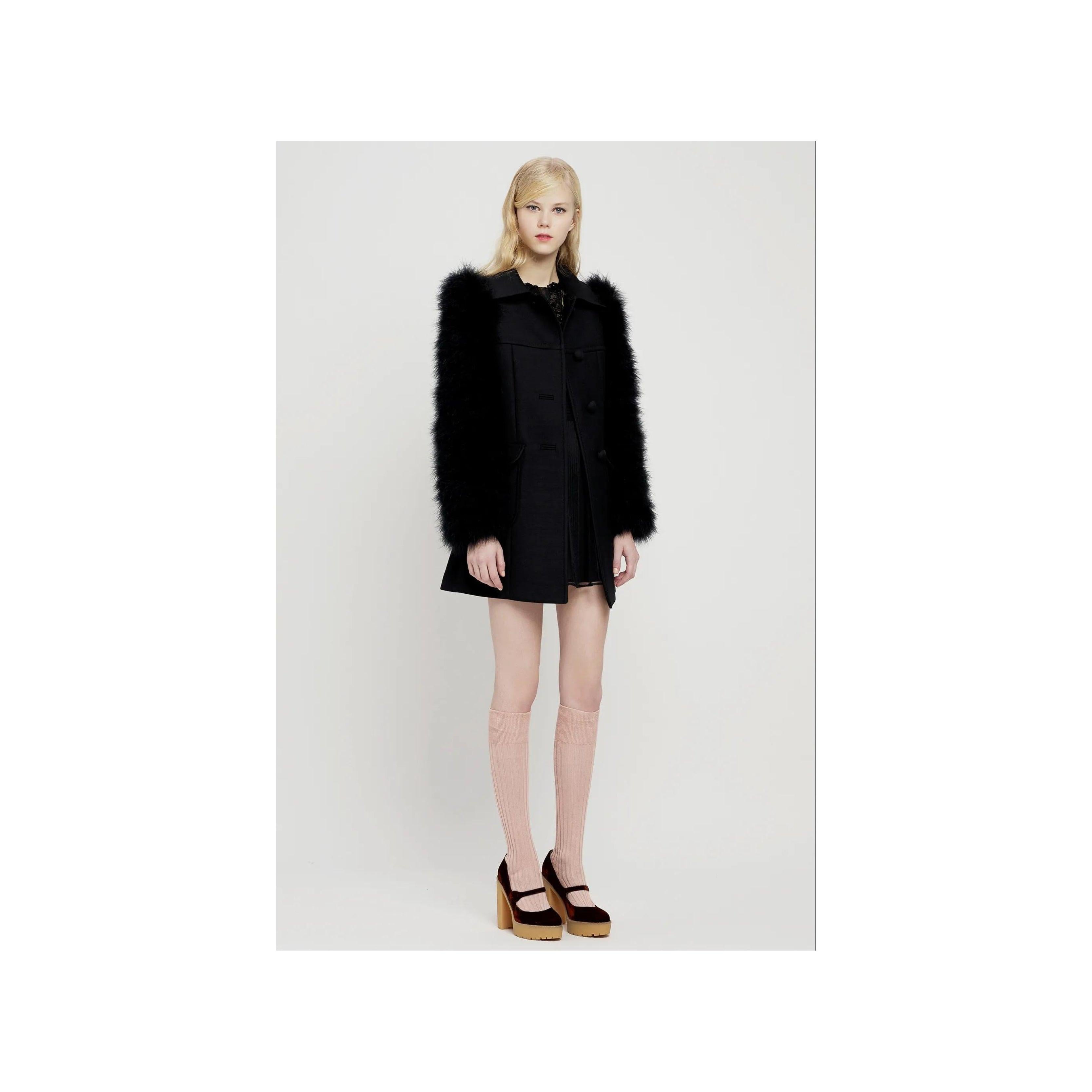 Expertly crafted from a luxurious wool blend, the Red Valentino Wool Coat exudes sophistication with its tailored fit and elegant fabric covered buttons. The standout feature of this coat are the unique turkey feather sleeves, adding a touch of