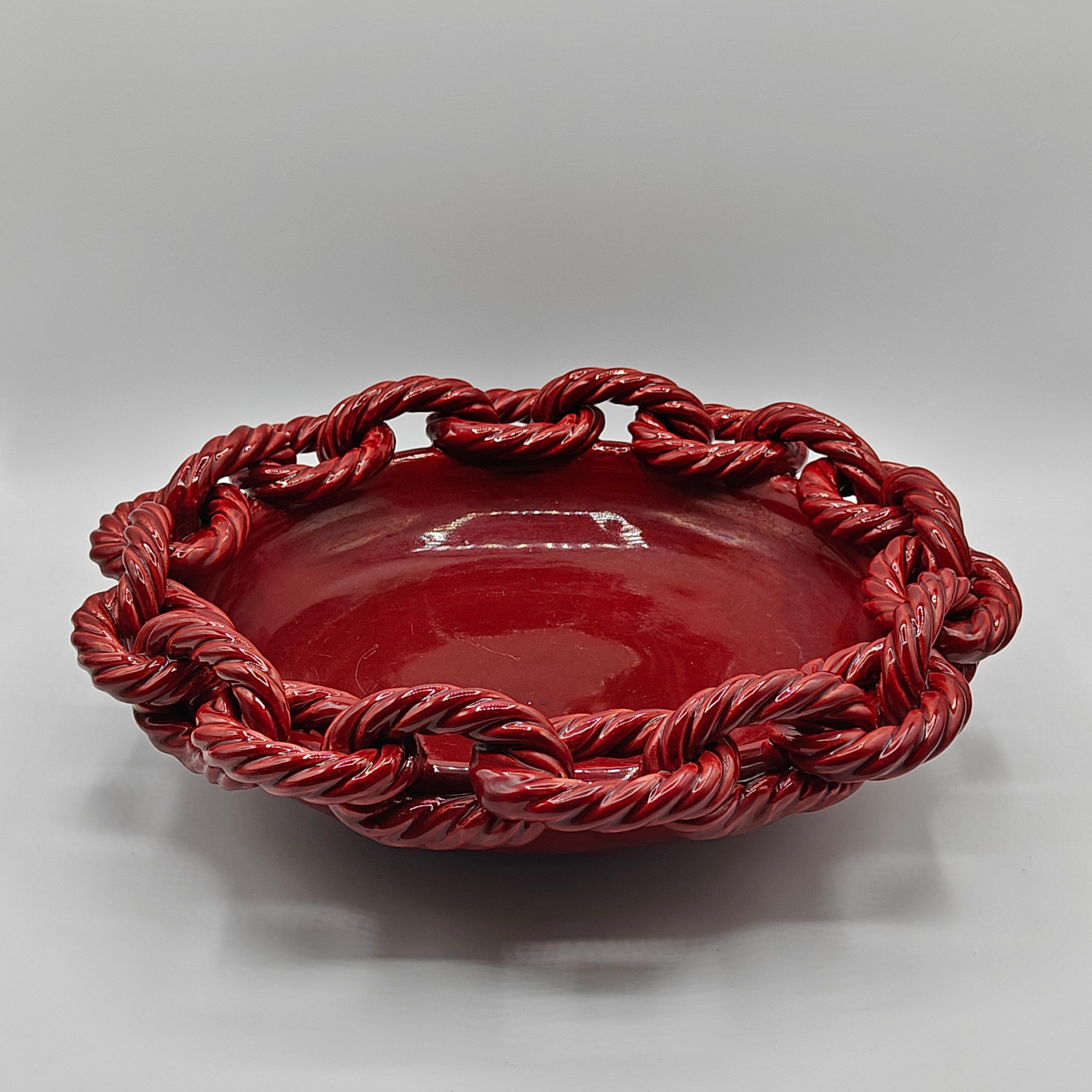 This ceramic bowl, crafted by Jean-Francois Daniel in the 1950s, hails from Vallauris, the renowned hub for ceramic artists during that era. The coupe, measuring 33 cm in diameter and 9 cm in height, showcases a striking red hue that adds a vibrant