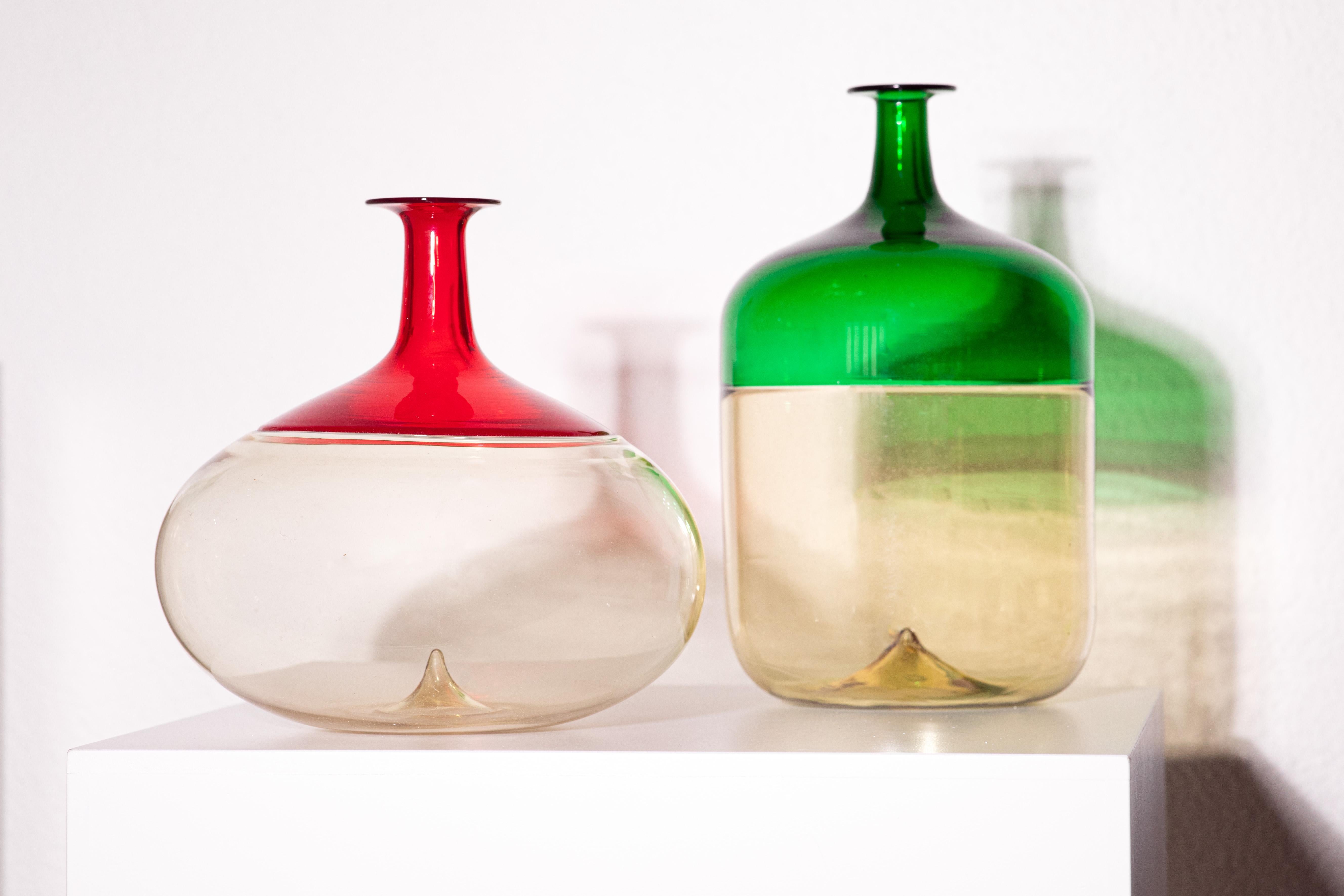 This exquisite red Murano glass vase is a stunning creation by the renowned Finnish designer Tapio Wirkkala for the prestigious Italian glassmaker Venini. Crafted in the 1990s, it embodies the perfect fusion of Scandinavian minimalism and Venetian