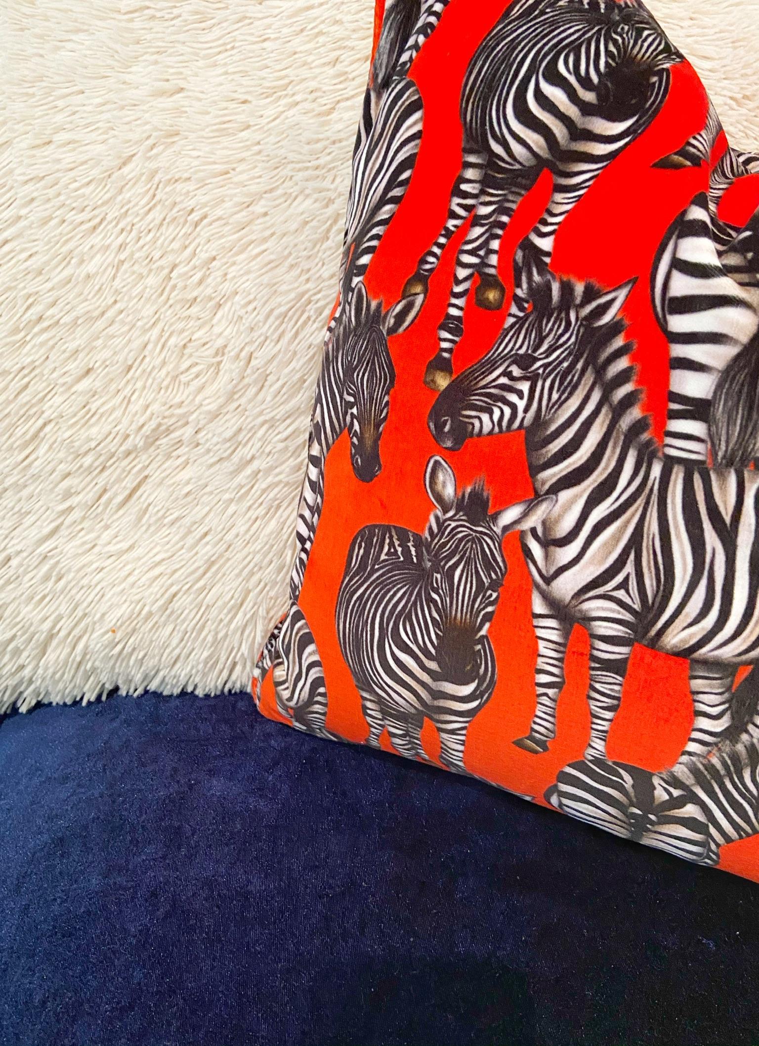 Red velvet zebra animal pillow.

This hand-drawn print by artist Charlotte Jade captures the zebra in a playful and yet eye-catching way. The zebras are extremely realistic and on this beautiful shade of red, will add that quirky and unique touch