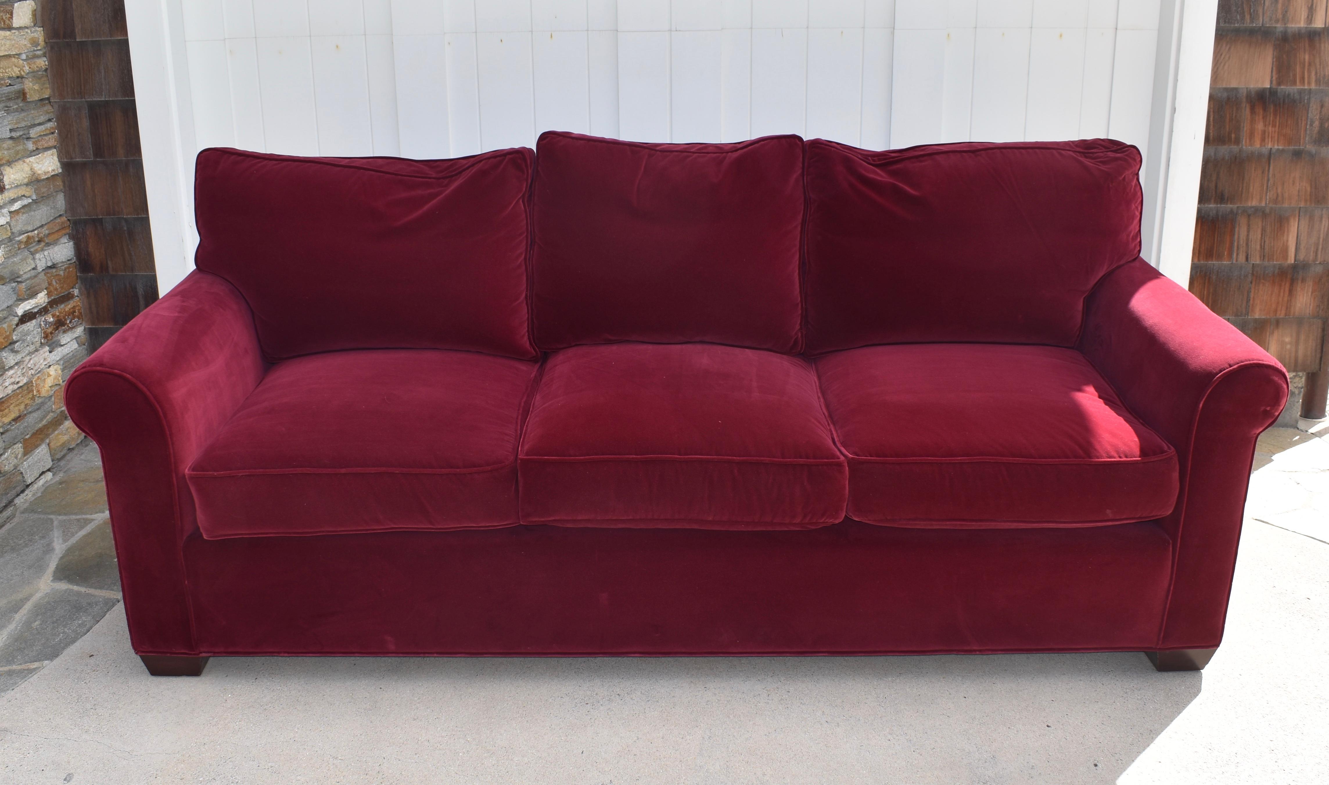 This decorator-built red velvet three seat sofa brings comfort, class, and a touch of glam to your space - upholstered in soft, rich crimson red velvet with welting, button tufting, zippered over stuffed down filled back cushions and thick foam seat