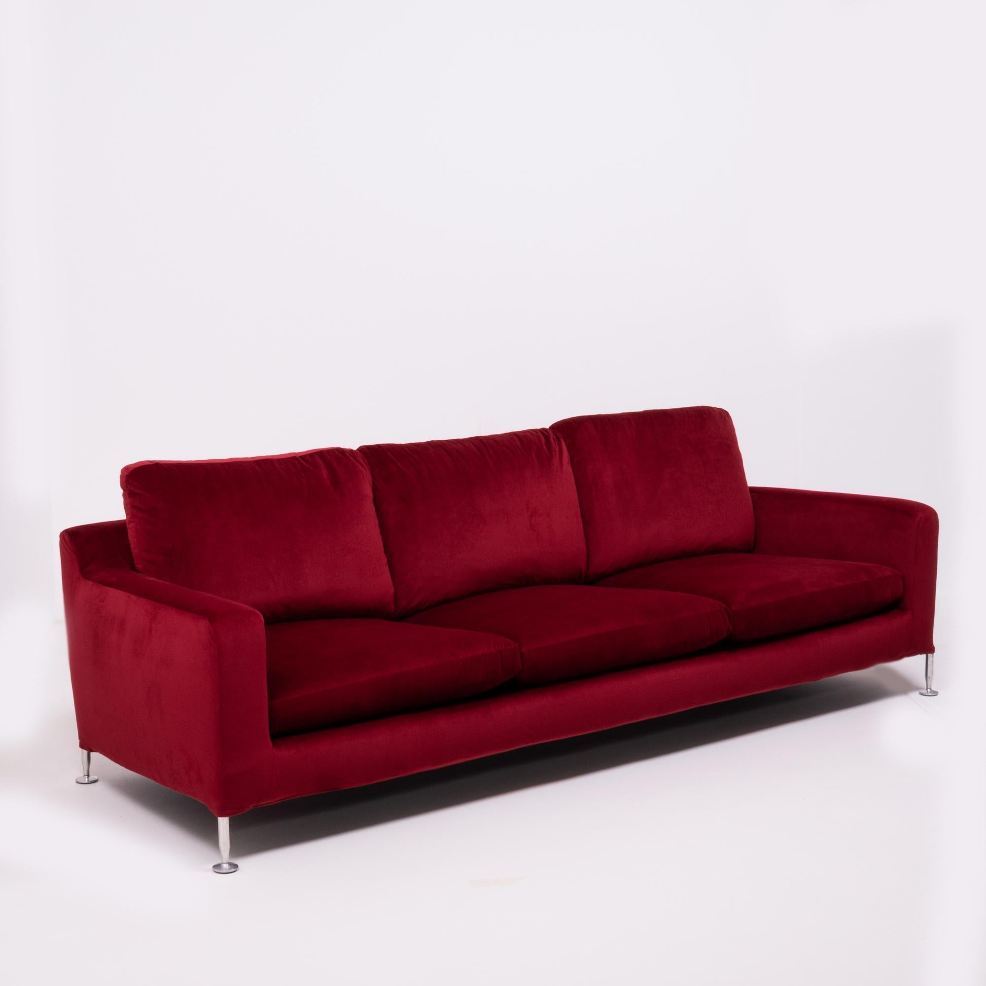 Originally designed in 1995 by Antonio Citterio for B&B Italia, the Harry sofa is named after the famous artist and furniture designer Harry Bertoia. 

Newly and fully reupholstered in sumptuous crimson red velvet fabric, the three-seat sofa