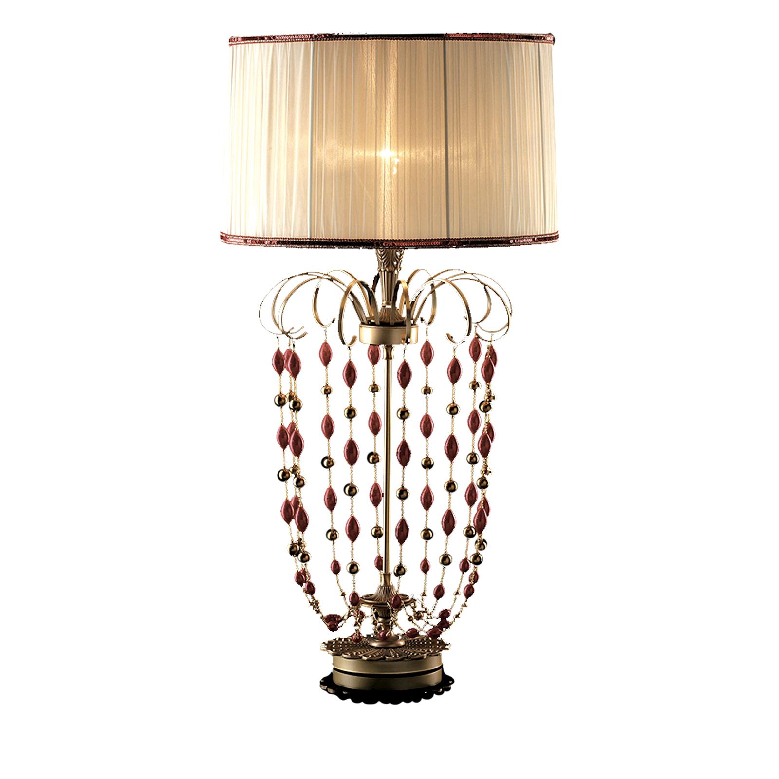 This charming table lamp will add a unique accent to an entryway, living room, or bedroom. The piece's metal structure is made up of a round base supporting a vertical rod adorned at the top with a series of spiral motifs from which delicate stings