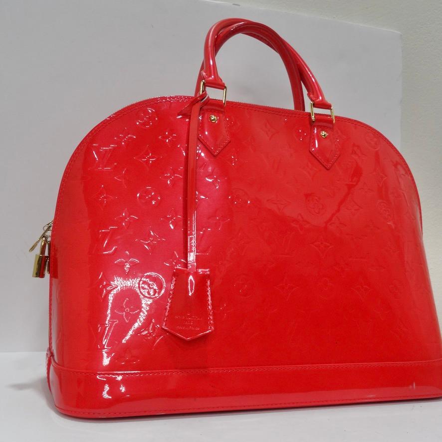 Beautiful Louis Vuitton handbag in their iconic Alma style circa 2008. Gorgeous patent red leather in LV's signature Vernis red is covered in a Louis Vuitton monogram, a subtle finishing touch that screams Louis Vuitton. This handbag is so shiny you