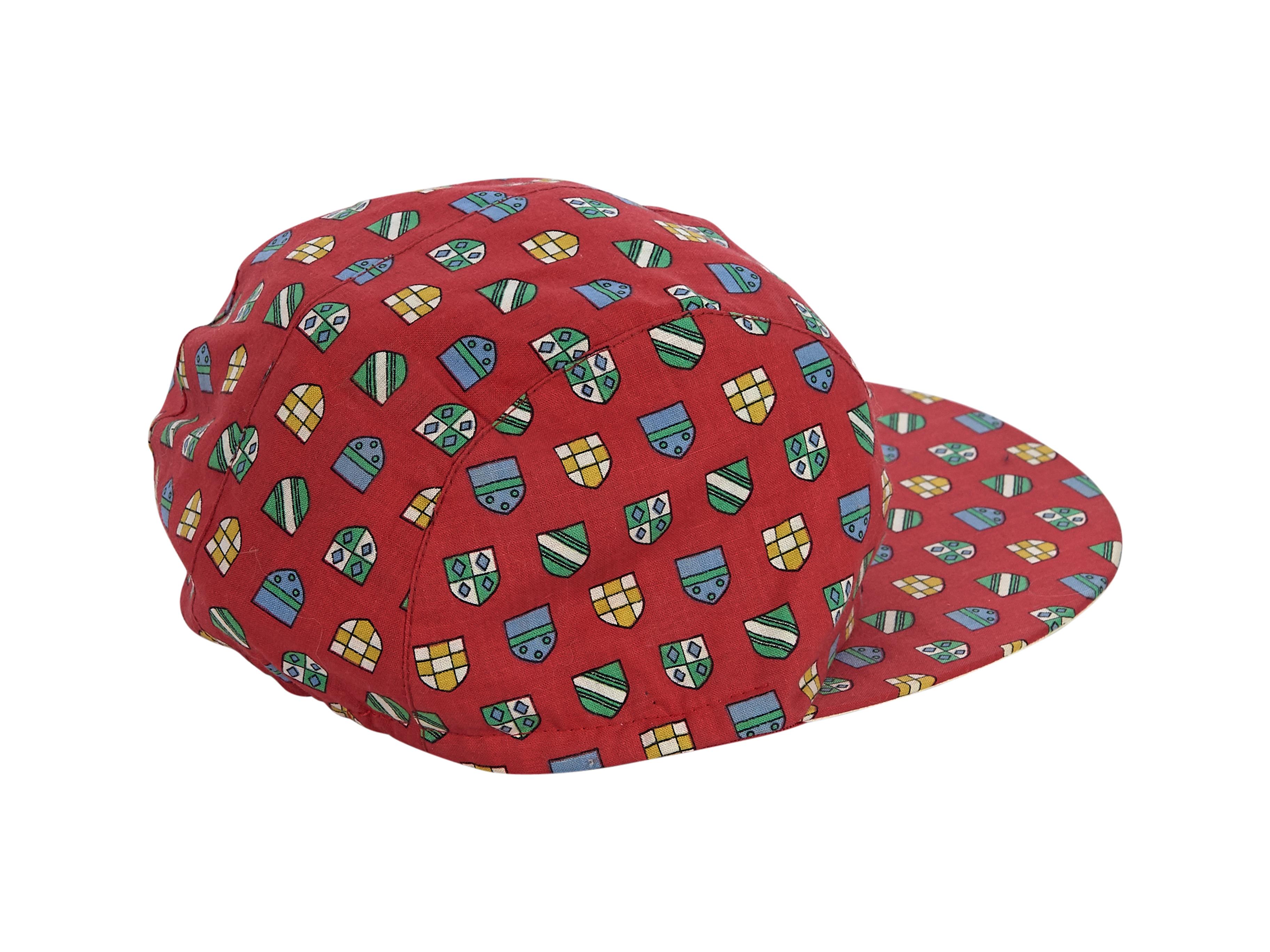 Product details:  Red shield printed cotton baseball hat by Gucci. Contrast embroidered GG logo at side. Elasticated at back. Style with a T-shirt and high-waist shorts. 5