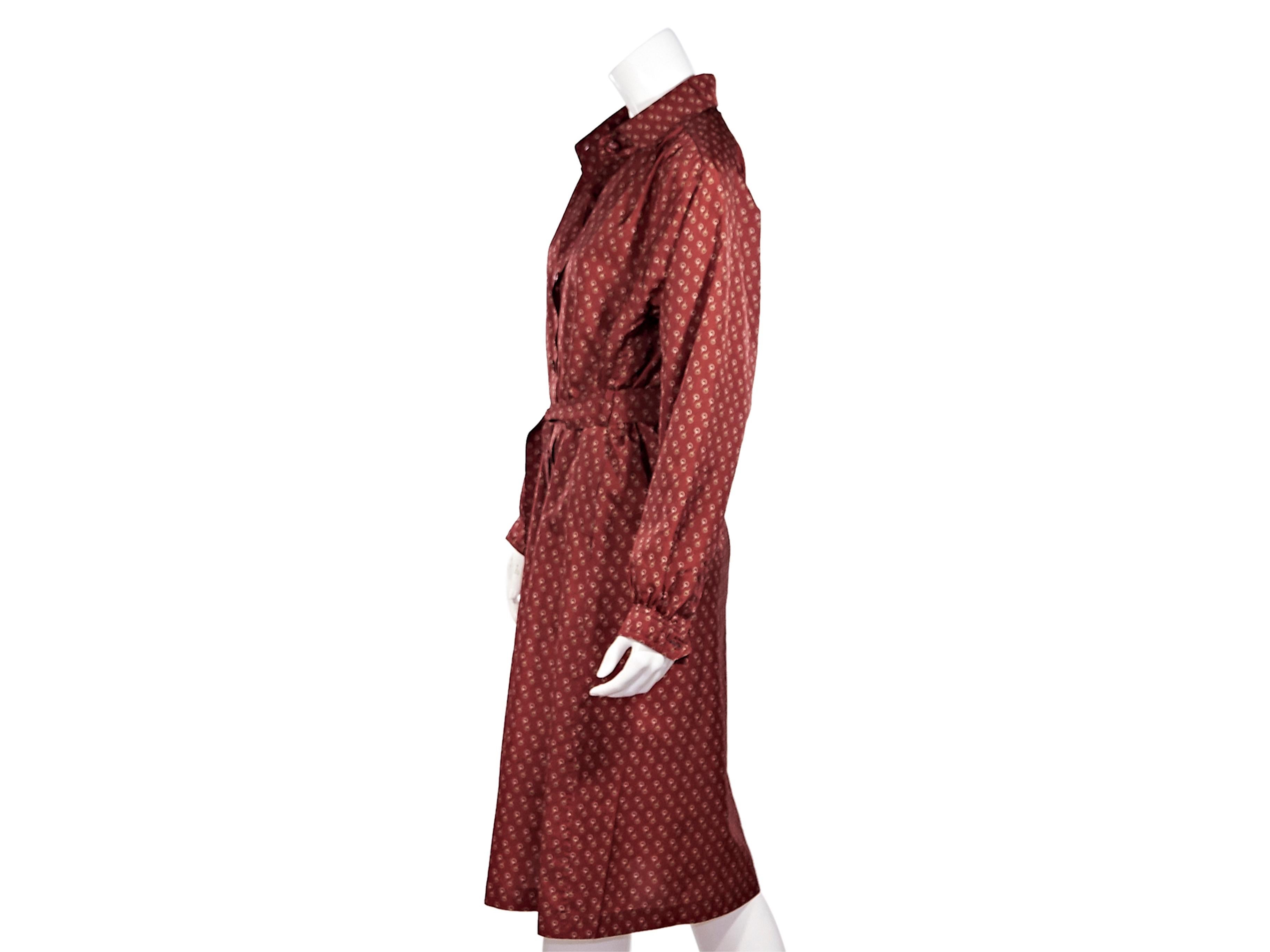 Product details:  Vintage red horsebit-printed shirtdress by Gucci.  Spread collar.  Long sleeves.  Button-front closure.  Self-tie belted waist.  Label size IT 46.  38