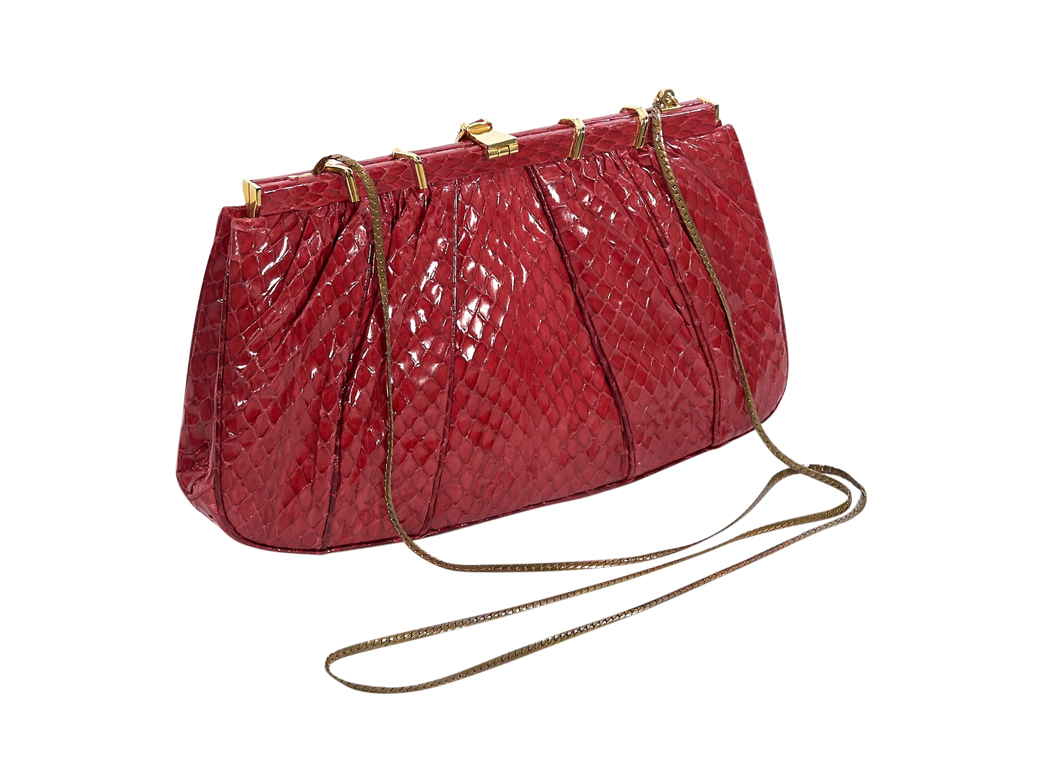 Product details:  Vintage red snakeskin clutch by Judith Leiber.  Tuck-away chain shoulder strap.  Top flip-lock closure.  Lined interior with inner zip pocket.  Goldtone hardware.  9