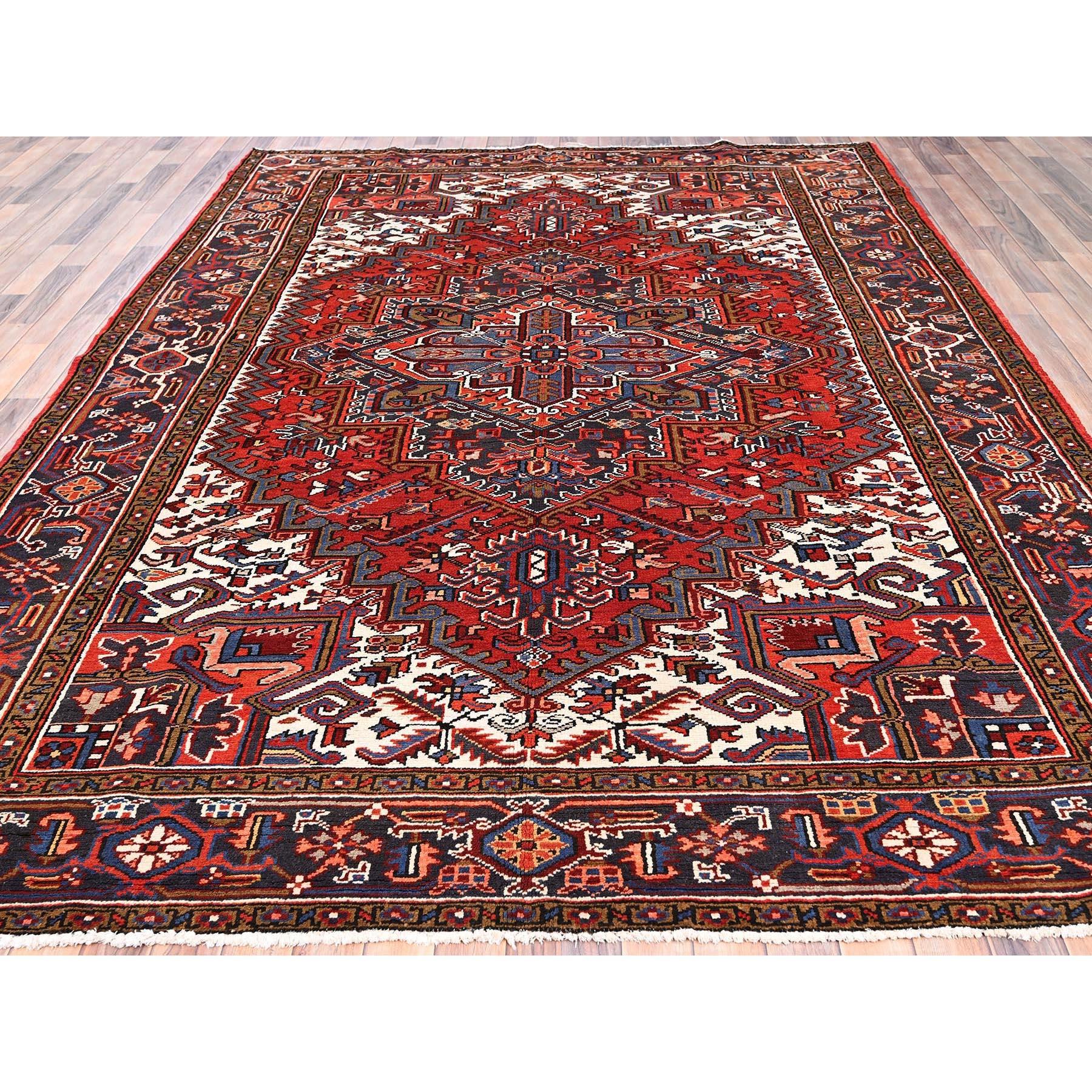 Hand-Knotted Red Vintage Persian Heriz Village Motif Rustic Feel Worn Wool Hand Knotted Rug For Sale