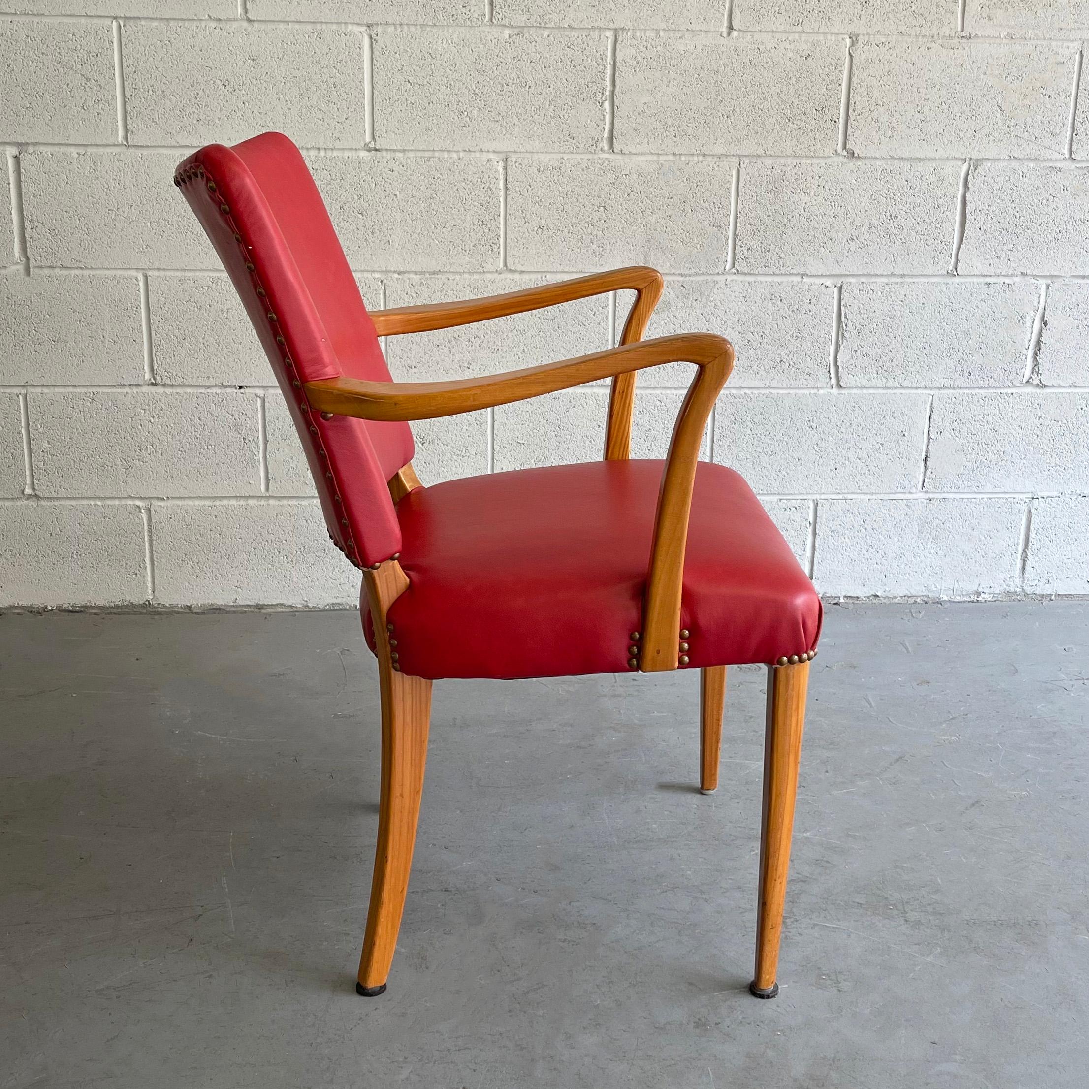 Midcentury, Biedermeier style armchair features an elegant cedar frame upholstered in red vinyl with nailhead detail.