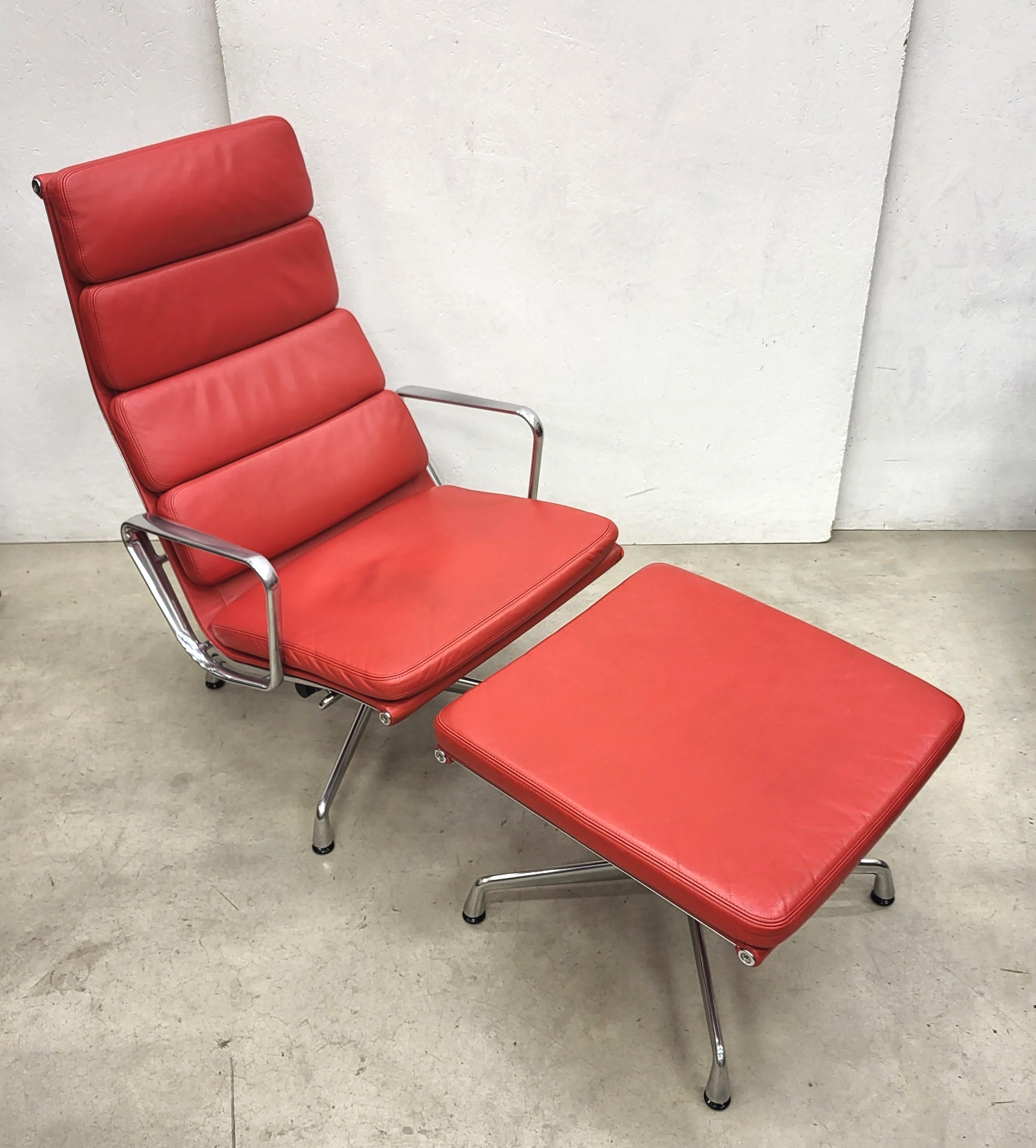 Very nice soft pad lounge chair model EA222 with ottoman produced by Vitra. 
The chair features a polished aluminium frame and was made in 2013.

The chair has a tilt mechanism which works very smoothly.

It has a wonderful red leather upholstery