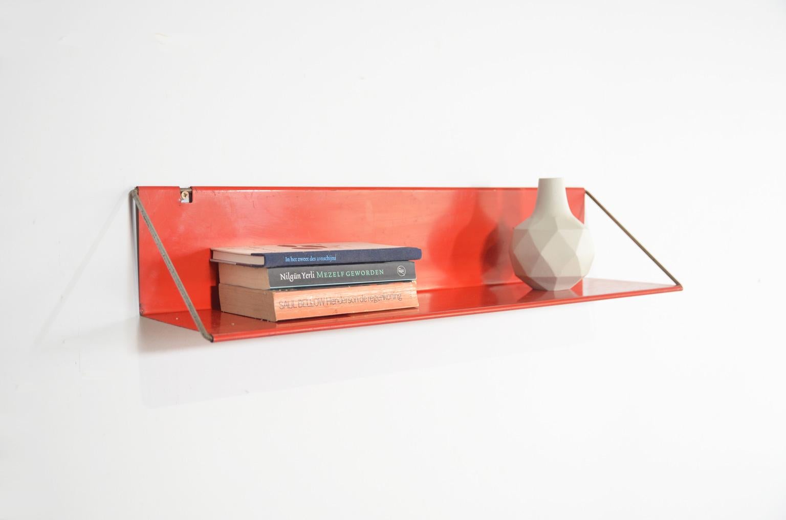 Constant Nieuwenhuys, the Dutch artist, musician, writer and co-founder of the Cobra art movement has also designed some items for the Dutch furniture company 't Spectrum. One of these was this red metal shelf, model 'Utrecht'.