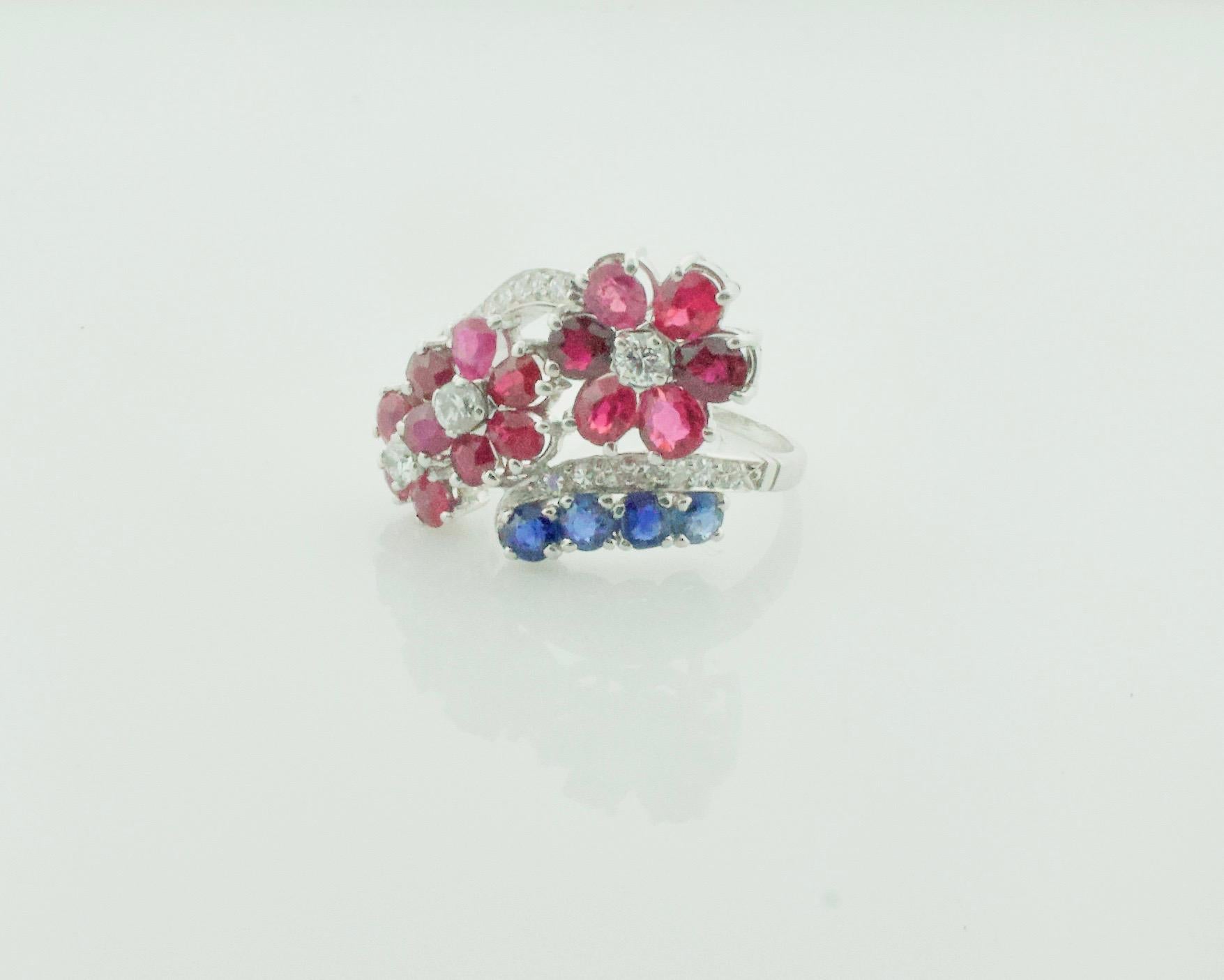 Red, White and Blue Ruby, Sapphire and Diamond Ring in Platinum Circa 1940's
Fifteen Round and Pear Shape Rubies Weighing 3.00 Carats Approximately 
Three Round Sapphires Weighing .60 Carats Approximately 
Three Round Cut Diamonds Weighing .30