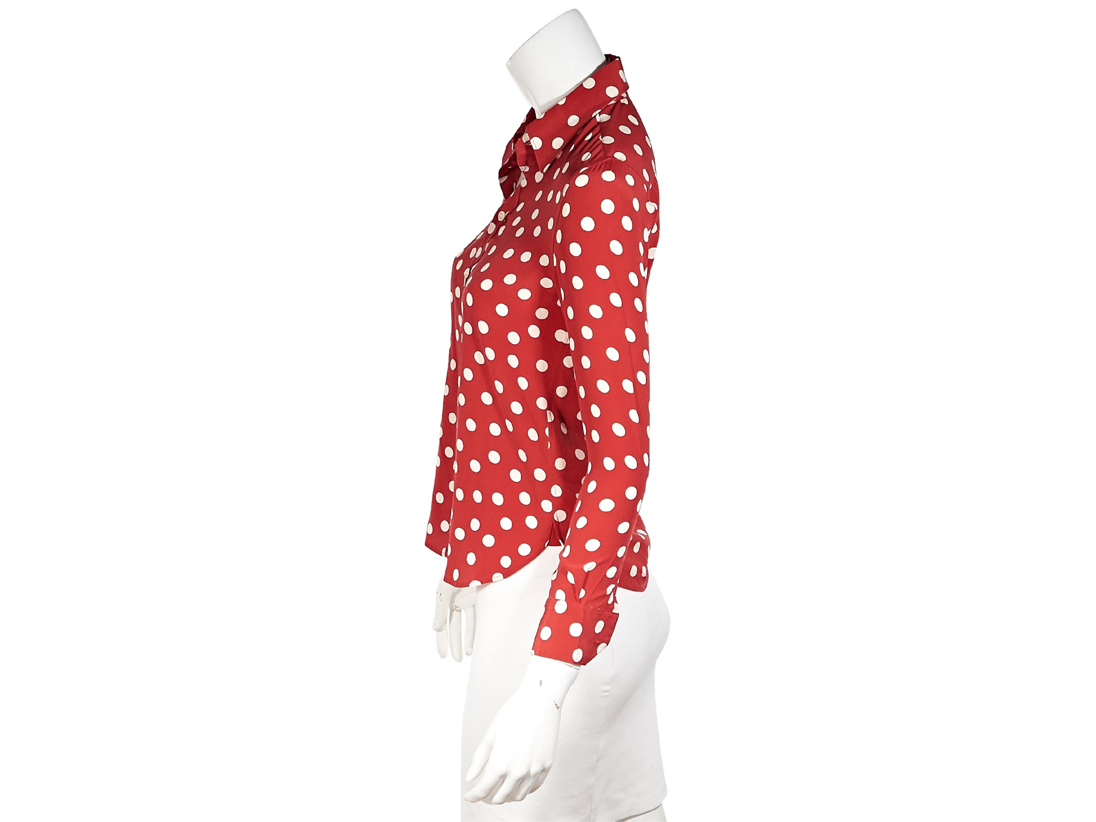 Product details:  Red and white polka-dot printed silk blouse by Saint Laurent.  Spread collar.  Three-quarter length sleeves.  Button-front closure.  Shirttail hem.  Label size FR 34.  34