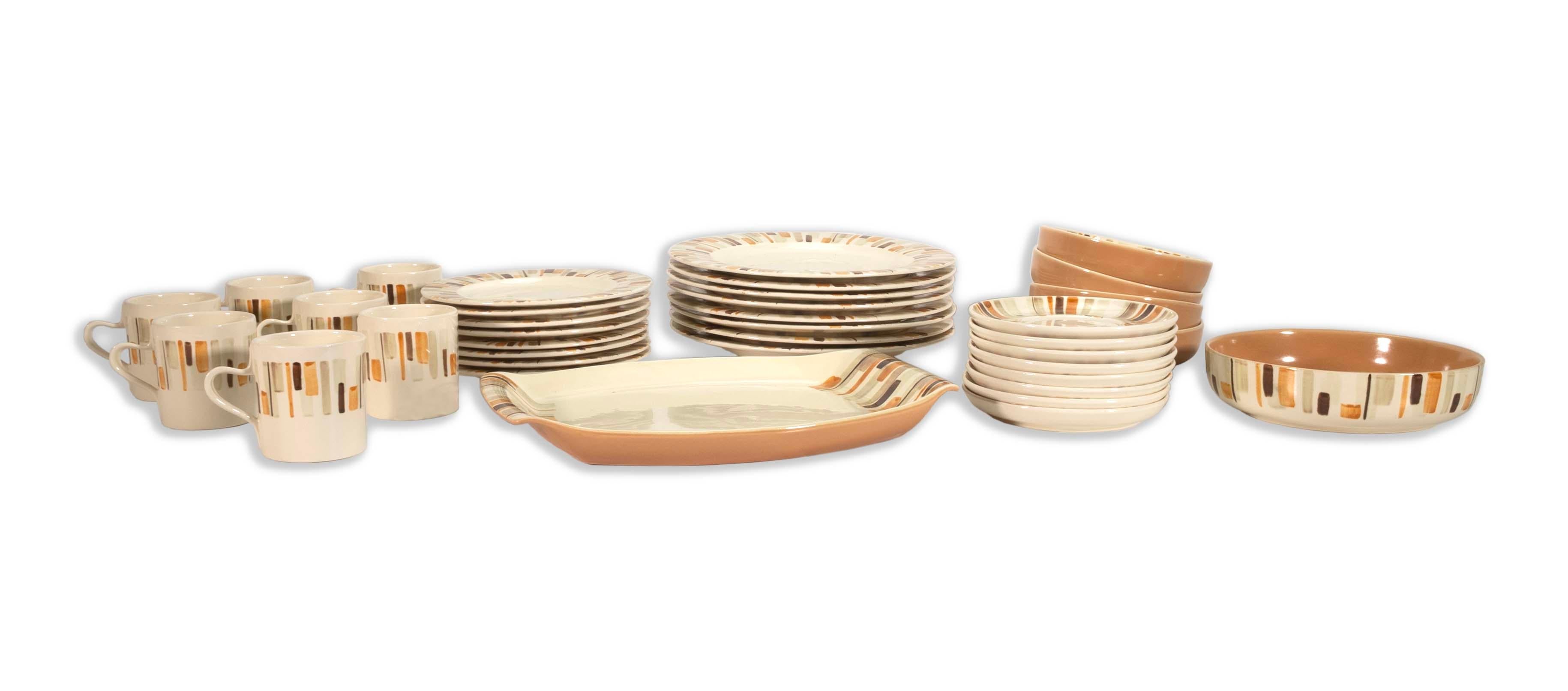 Charming and stylish, this Red Wing Desert Sun China Set features 37 exquisite pieces, perfect for any mid-century modern enthusiast. The set includes plates, bowls, and mugs, all adorned with a warm, earthy pattern that adds a retro flair to your