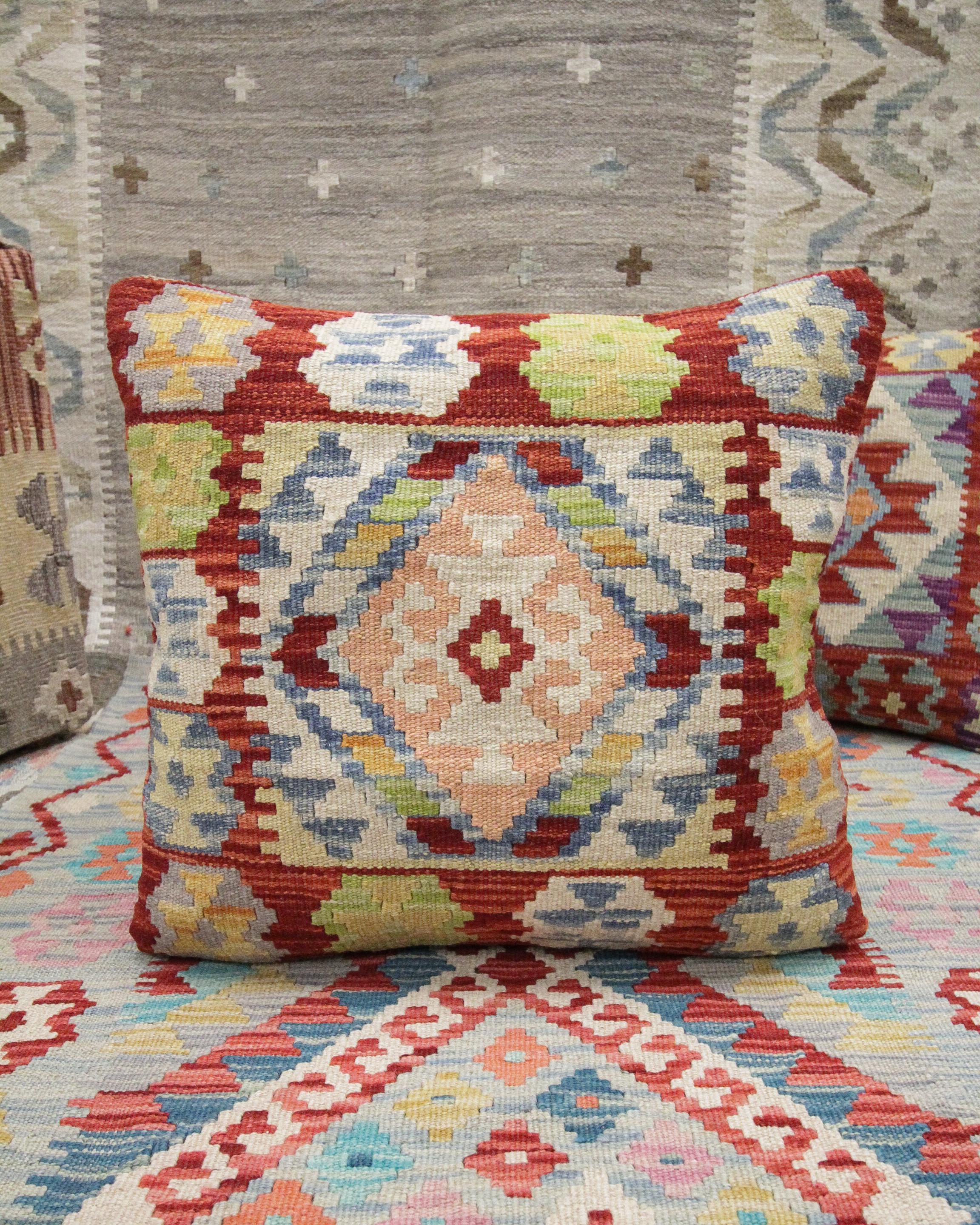 This new traditional Kilim cushion cover is a handwoven piece constructed in the early 21st century. The design has been delicately woven by hand and features a symmetrical geometric pattern that is sure to Stand out on any sofa or armchair! This