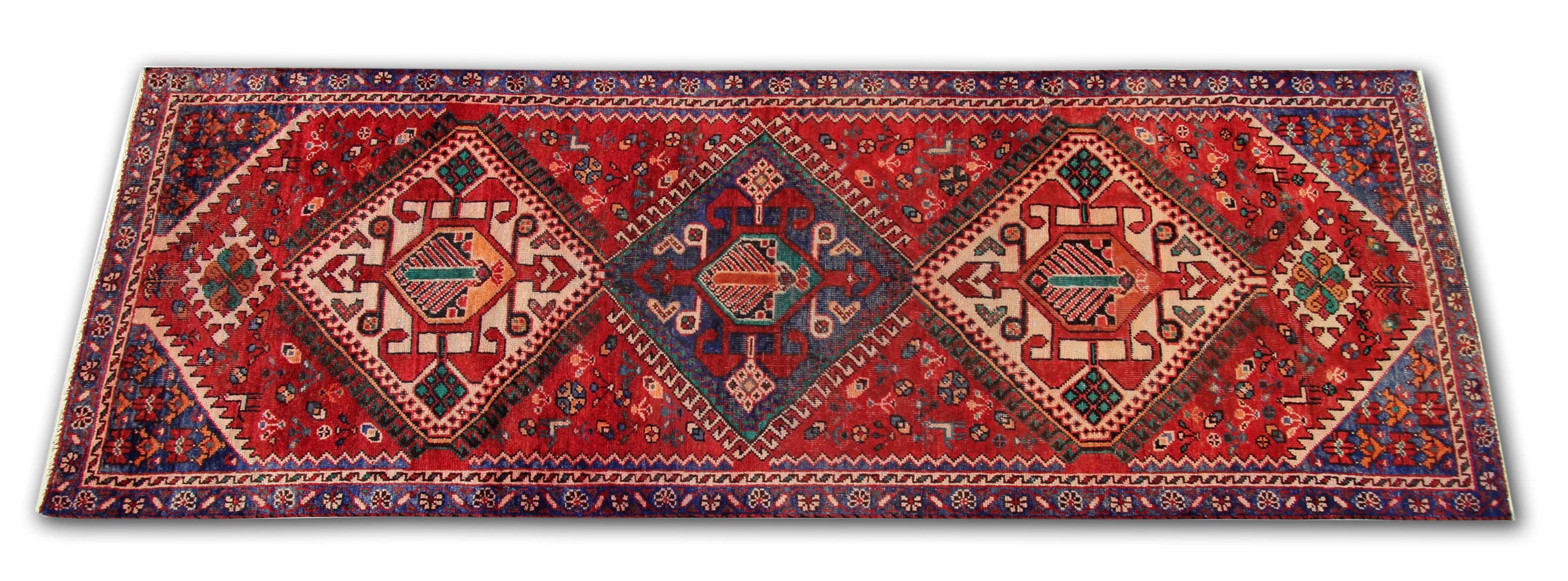 Are you looking for a new vintage carpet to add texture and style to your home? Then look no further. This fine wool area rug has been woven with a repeat medallion tribal pattern on a rich red background with cream, blue brown and beige accents