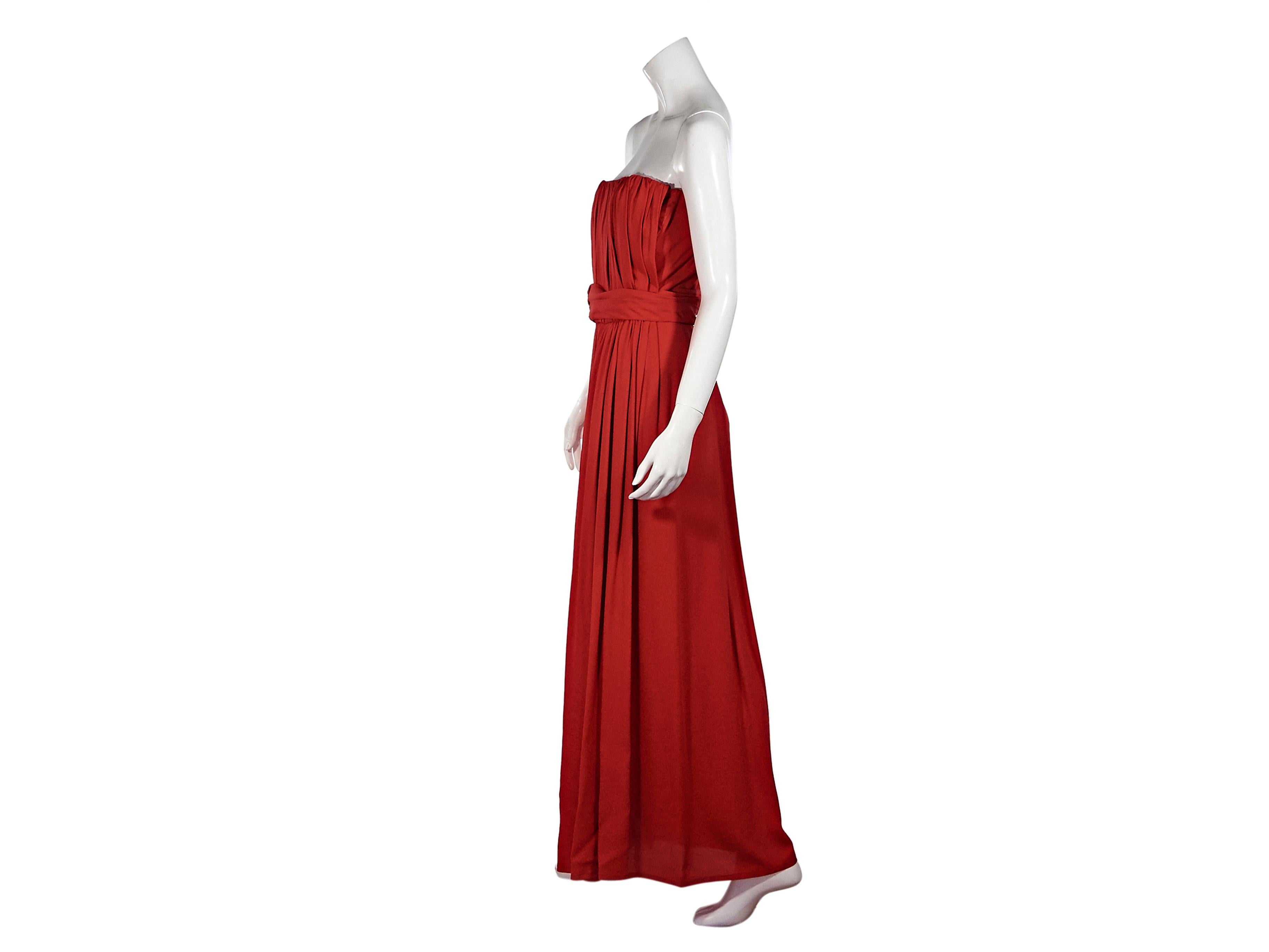 Product details:  Red strapless ruched gown by Yves Saint Laurent.  Banded waist detail.  Concealed side zip closure.  Inset boning and bust band for a structured silhouette.  34