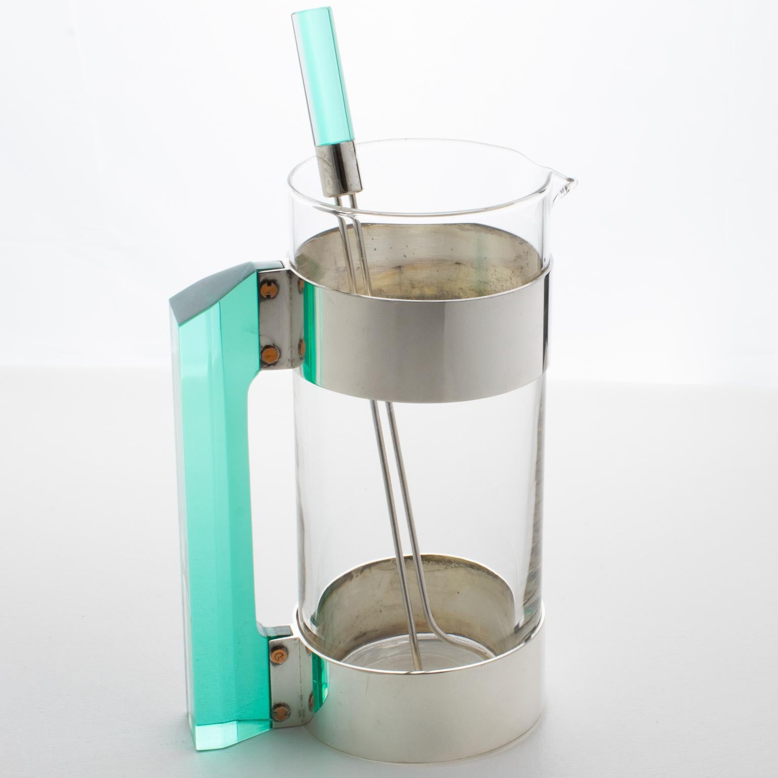 Italian designer Rede Guzzini designed this exquisite barware ensemble circa 1970. This bar accessory includes a Martini cocktail pitcher and its pairing stirrer stick. The molded glass container has a silver plate and copper metal framing