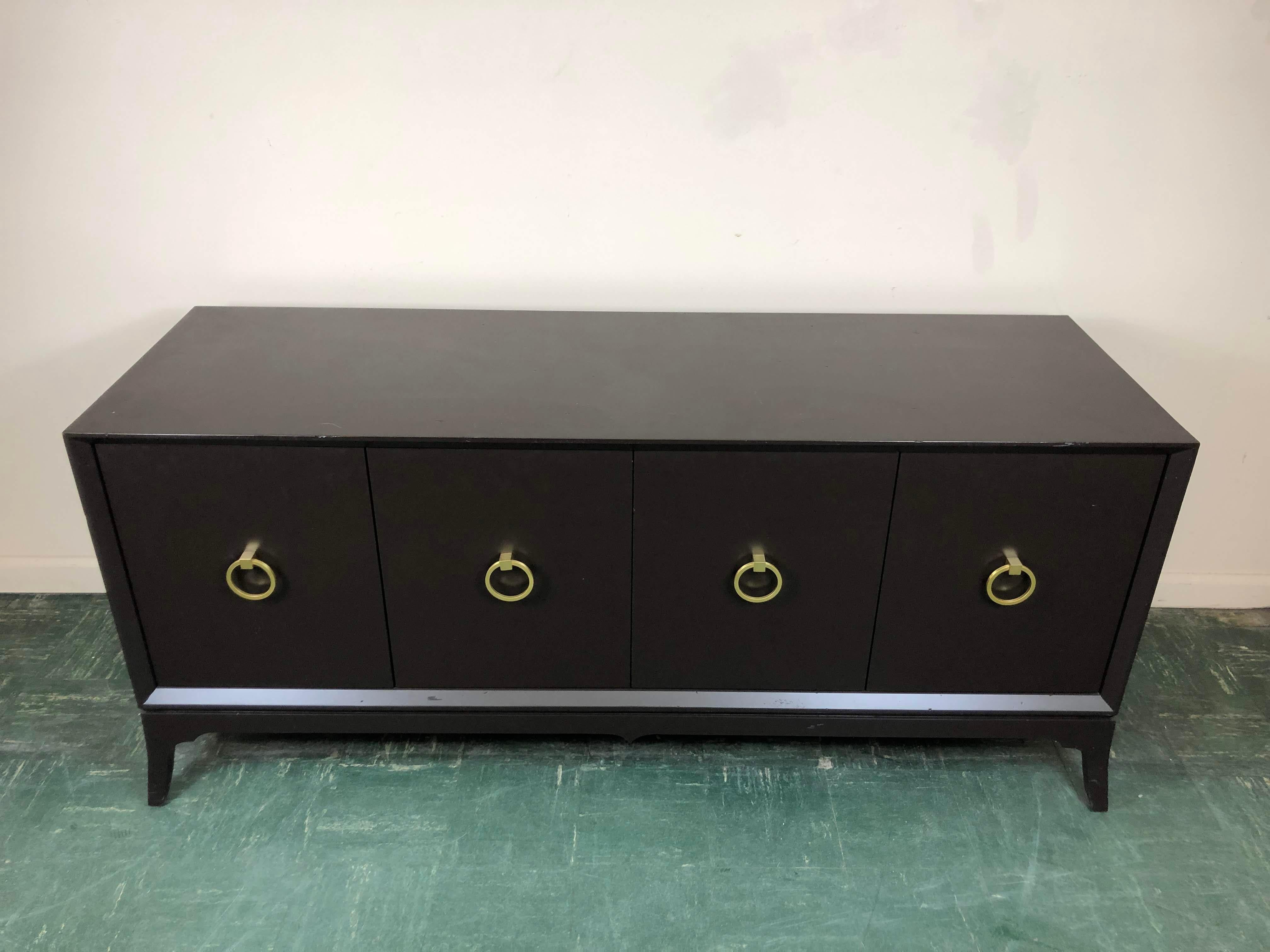 Redford House Bennett black TV console with circular brass hardware.