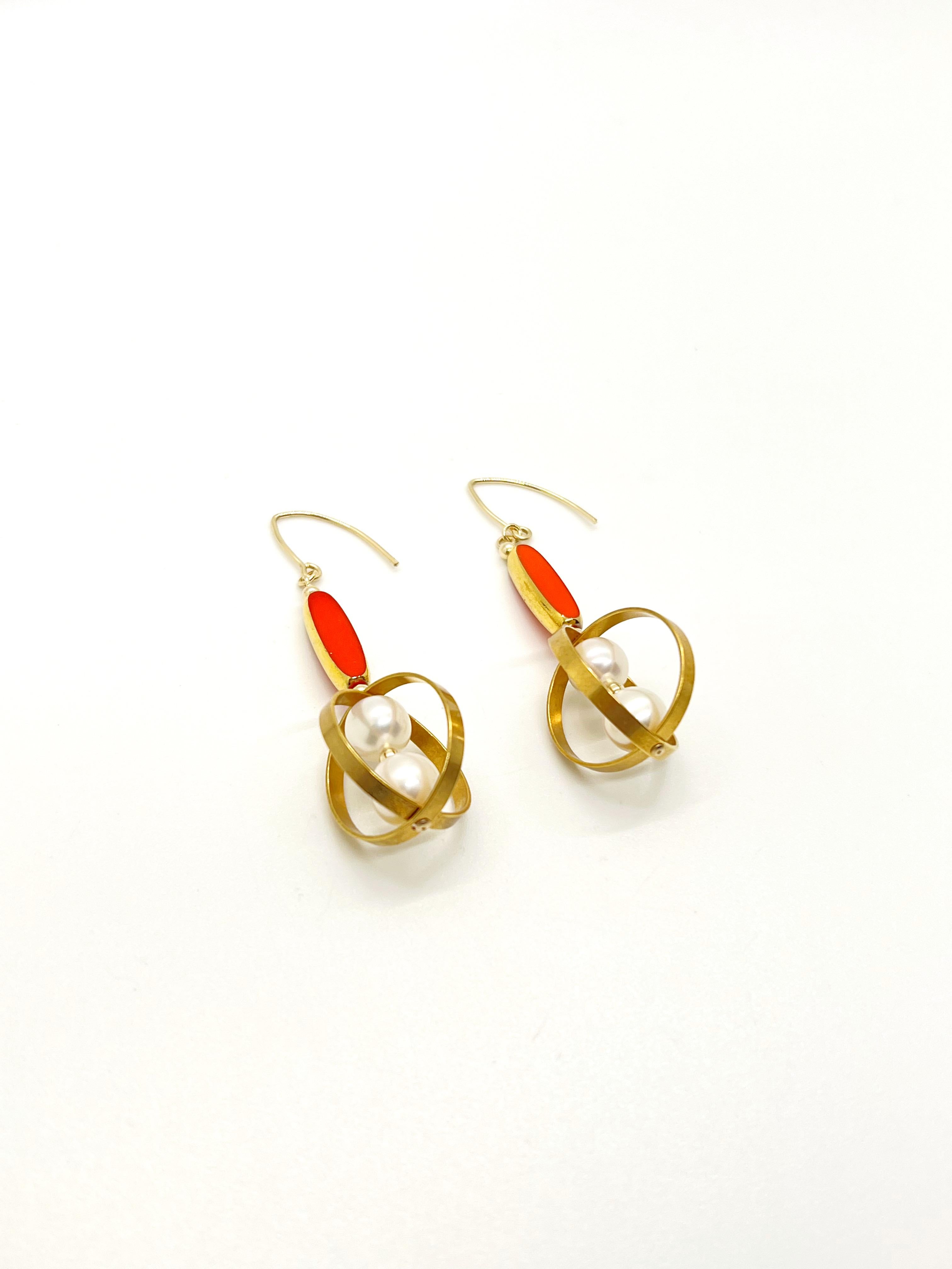 These earrings are made to order.

These earrings are composed of German Vintage Glass Beads that are edged with 24K gold. It is incorporated with freshwater pearls set in a geometric orbital frame.

The vintage glass beads that is framed with 24K