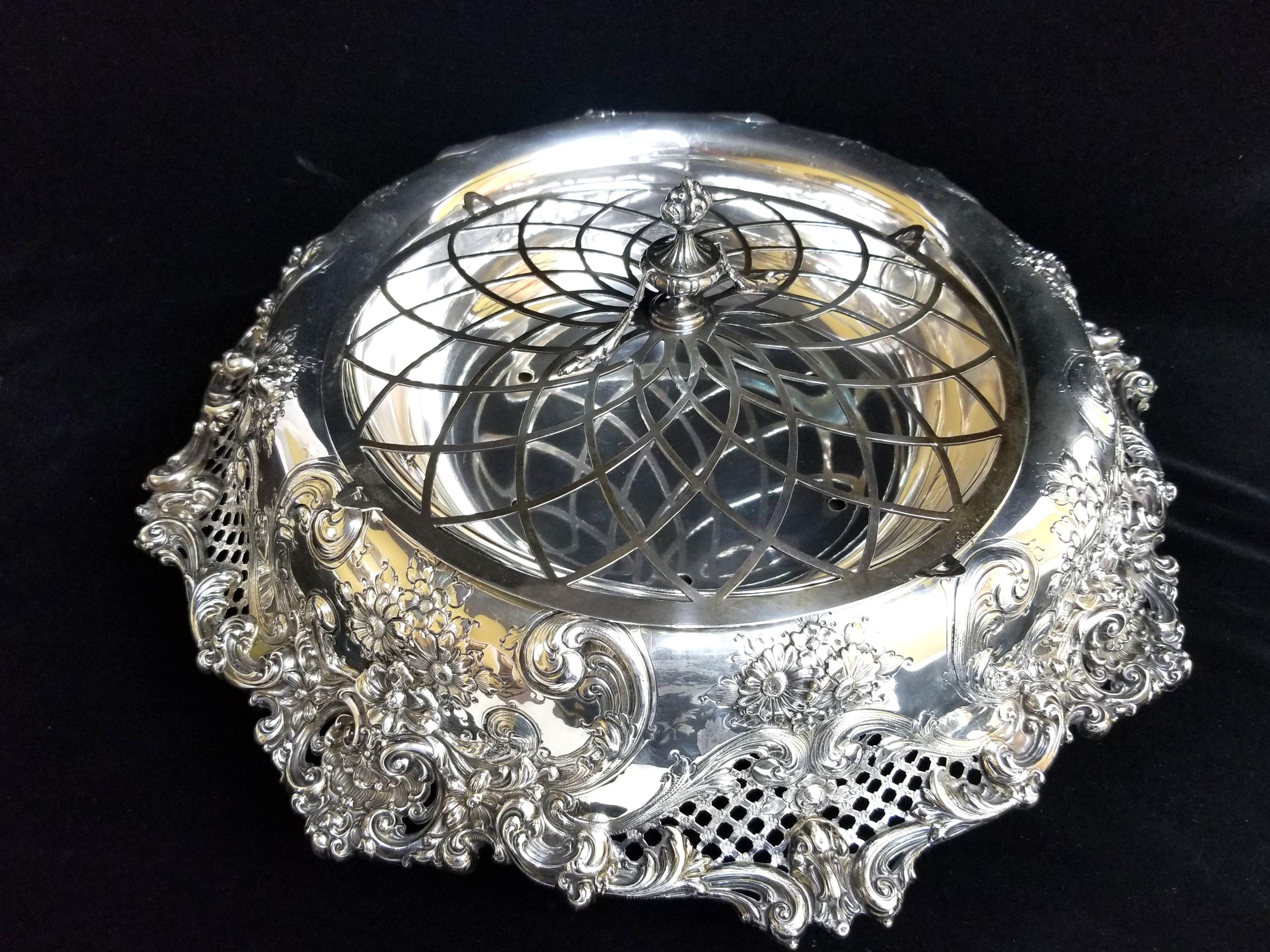 Outstanding antique Redlich & Co. sterling silver and silver plate centerpiece. The main body of the centerpiece on a pedestal has intricate art nouveau style floral engravings and piercings at each side. It has a removable silver-plated bowl and