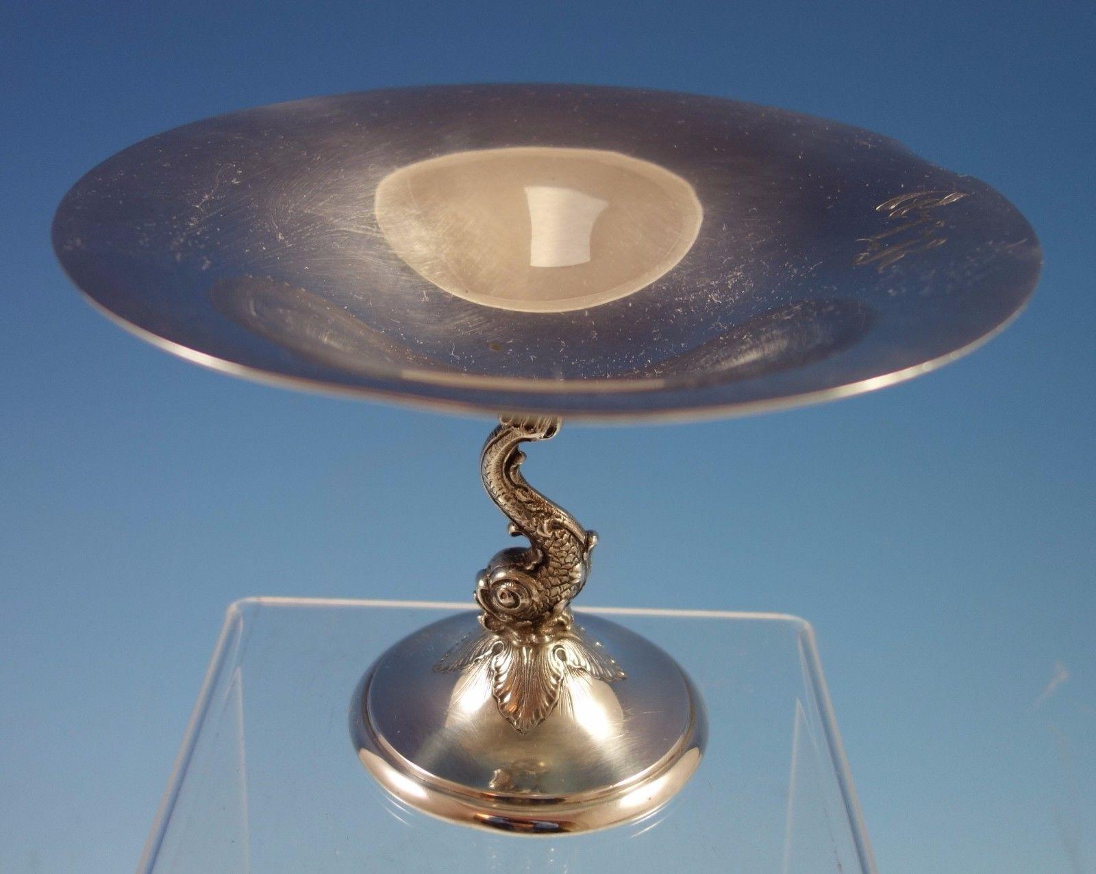 Redlich Redlich sterling silver compote with a 3-D fish base. The piece is marked with #8847, measures 4 3/8 tall and 6 diameter, and weighs 7.04 ozt. The vintage monogram (see photos), can be removed upon request. It is in excellent condition.