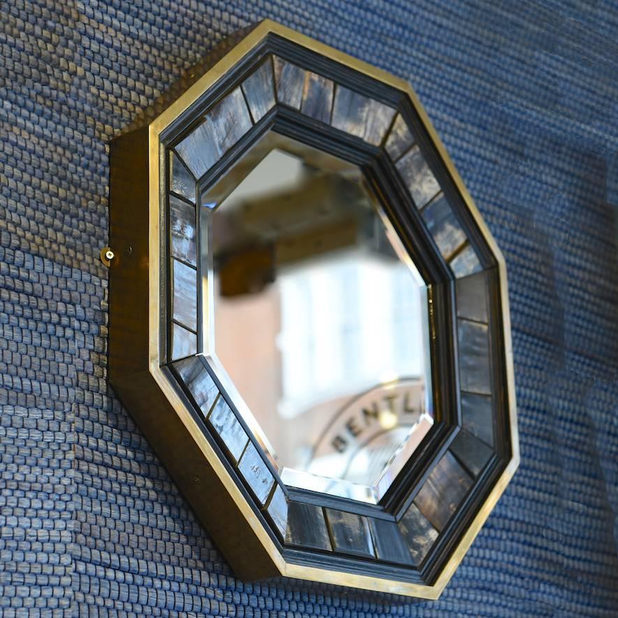 Octagonal brass framed bevelled glass mirror with inset Horn and ebonised wood surround, by Antony Redmile, circa 1970.

Selling from his shop at 73 Pimlico Road in the 1960s and 1970s, designer J. Antony Redmile was inspired by the eclectic