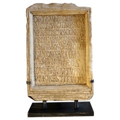 Reduced-size inscription as on the famous Roman epitaph of the Coliseum