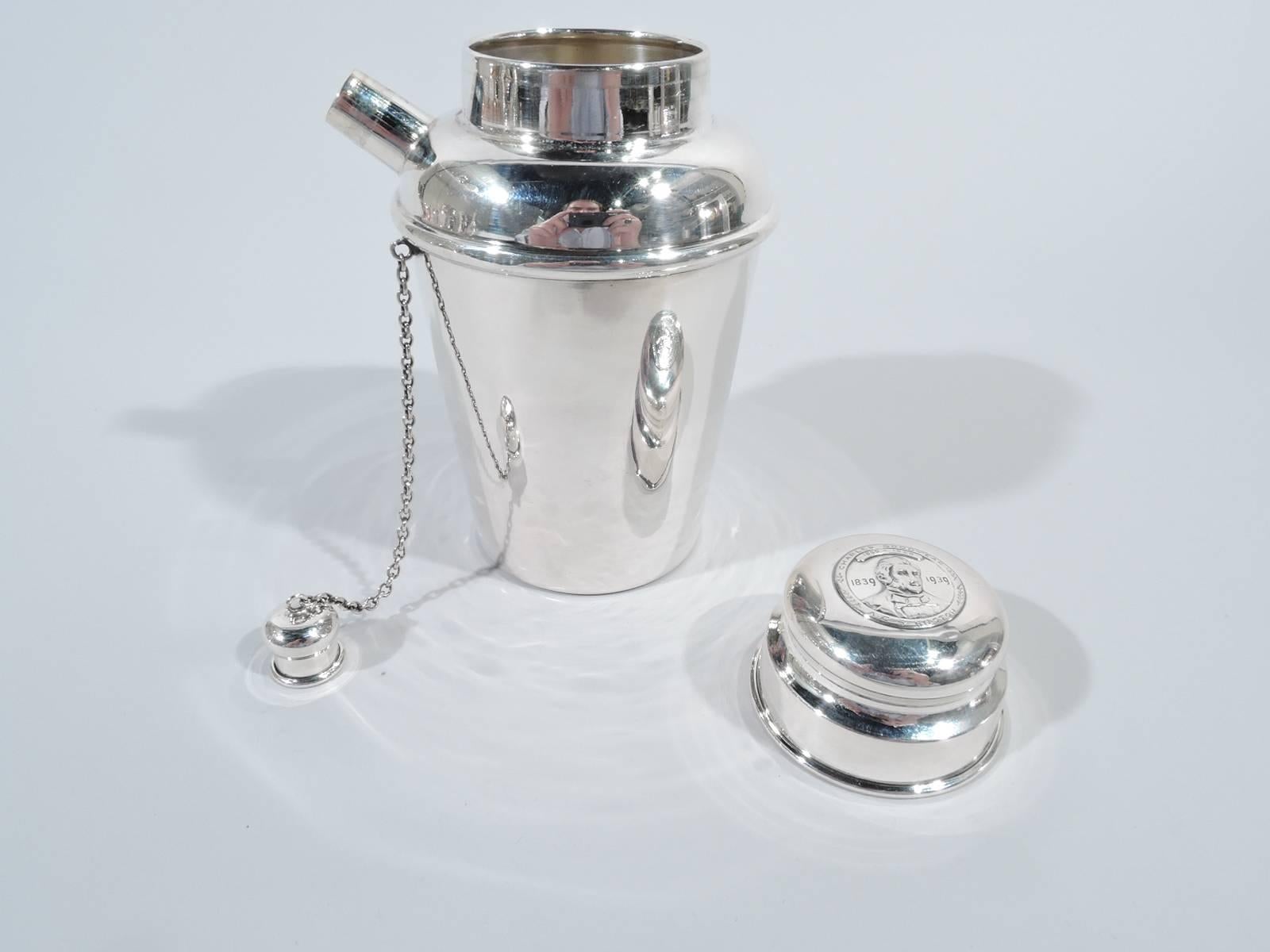Midcentury sterling silver mini martini shaker. Made by Reed & Barton in Taunton, Mass. Straight and tapering bowl, curved shoulders, stubby diagonal spout with built-in strainer and chained and snug-fitting cap, and short neck with cover. On cover