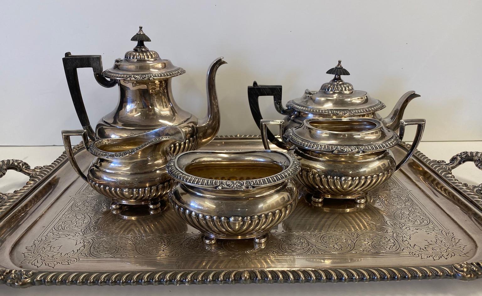 This is a Reed and Barton silver plate tea and coffee (6) piece set including a coffee pot, tea pot, sugar bowl, creamer, waste bowl, and a large, matching serving tray, circa 1935. All the individual pieces are monogramed AES. The sugar bowl is