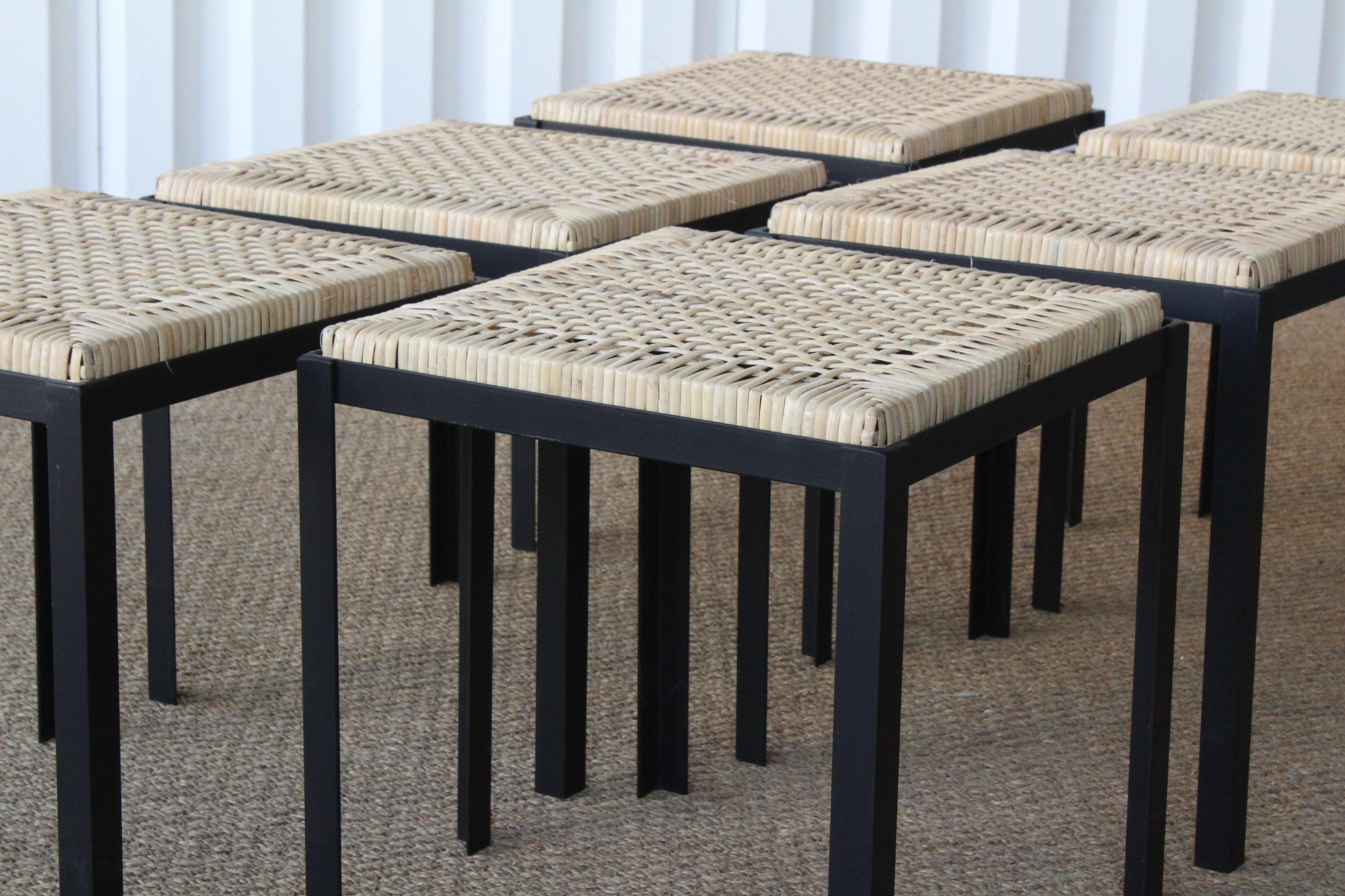 Hand woven reed and iron stools by Danny Ho Fong for Tropi-Cal, U.S.A, 1960s. Completely restored with new hand woven reed tops and newly powdercoated iron bases. Six available, sold individually.