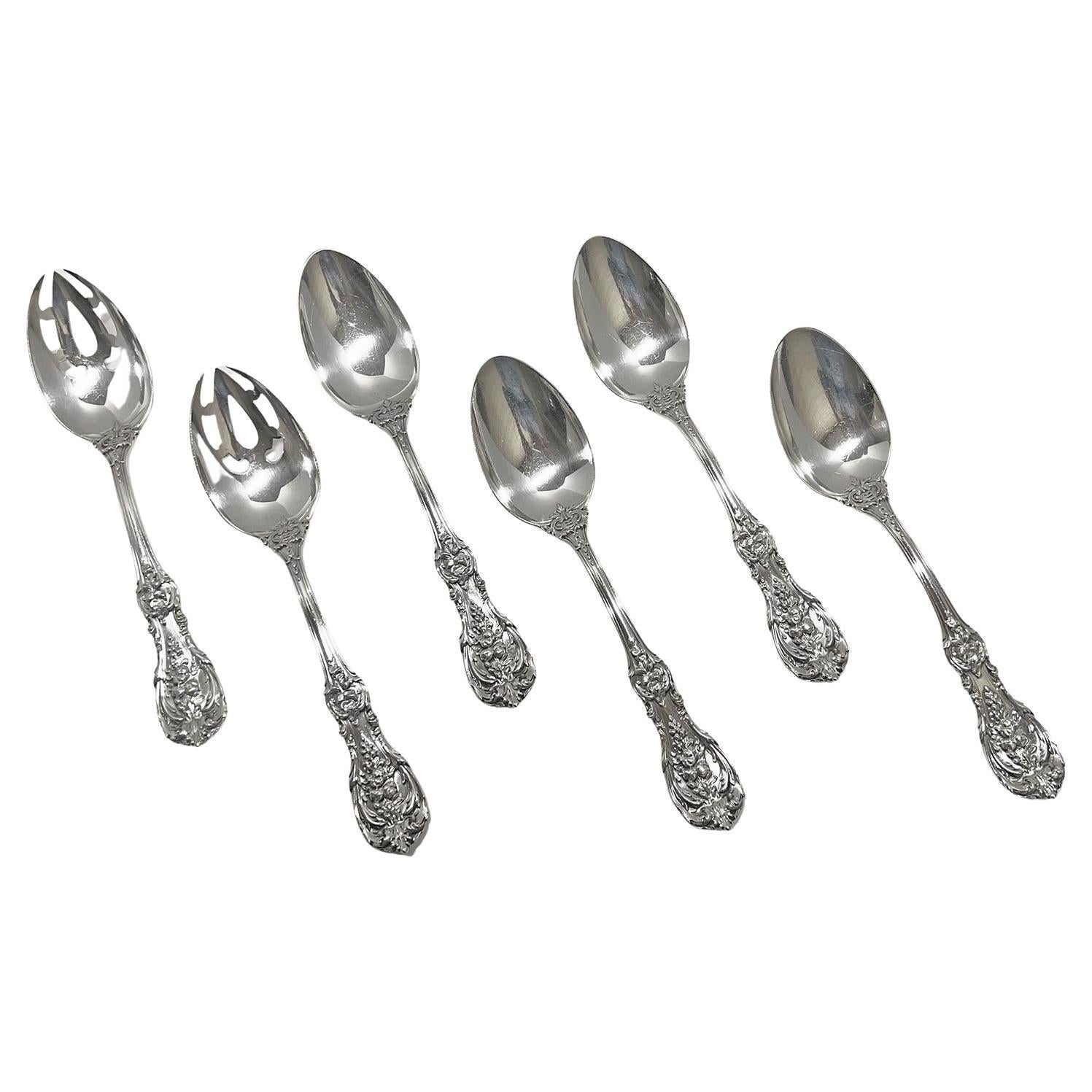 A 185-piece sterling silver flatware and serving piece set in the Francis I pattern by Reed & Barton. The ornate handles on the flatware are decorated with scrollwork, leaves, blossoms, and fruit.

The set consists of twelve dinner knives, twelve