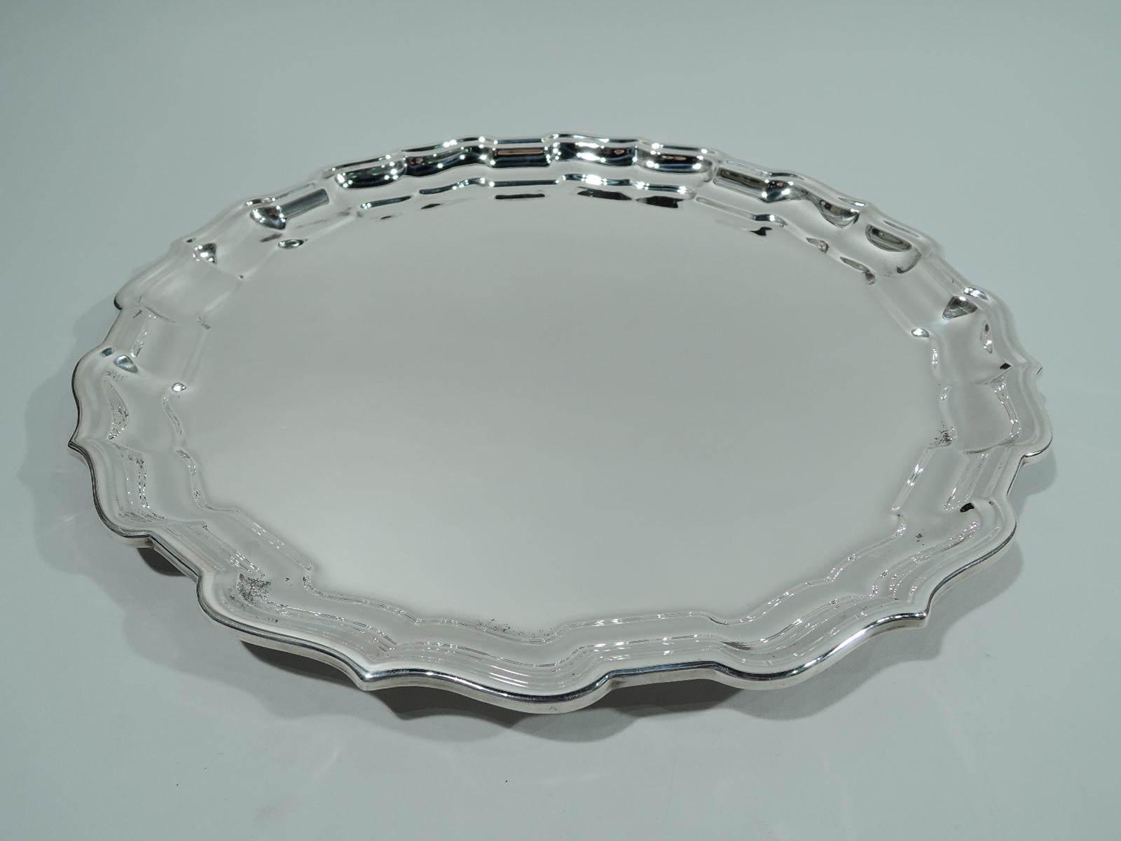 Chippendale sterling silver tray. Made by Reed & Barton in Taunton, Mass. Round with molded curvilinear ogee piecrust rim. Fully marked including maker’s stamp, pattern name, and no. X366. Weight: 29 troy ounces.