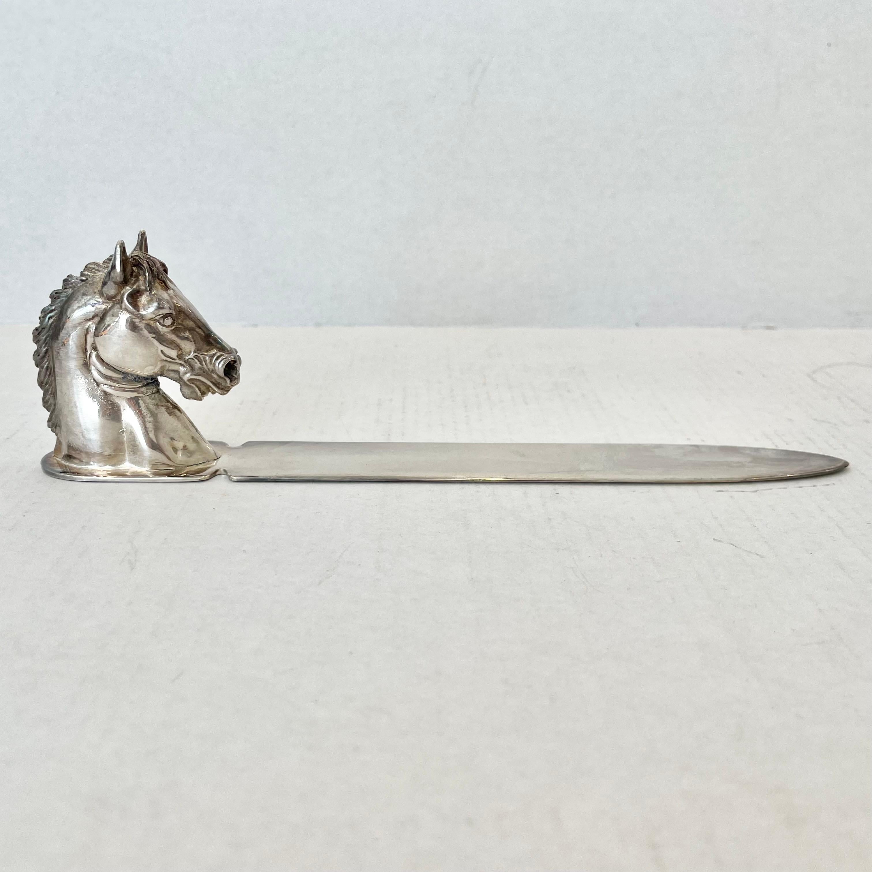 Great Reed & Barton letter opener with a detailed horse head handle in solid silver plated metal. Reed & Barton 274 stamped on the base of the handle. Elegant patina to the silver. This piece is a stunning and practical addition to elevate your
