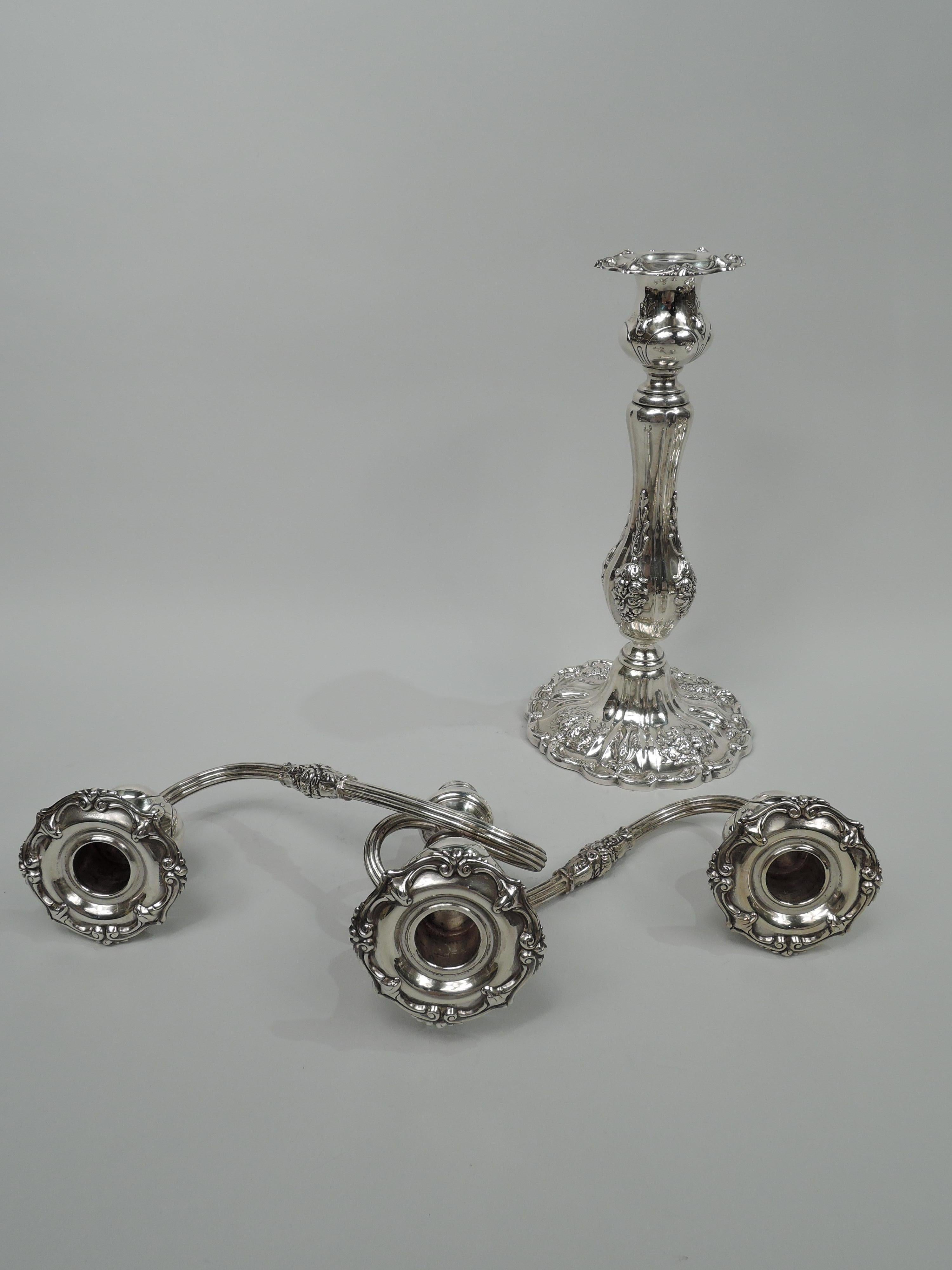 Francis I sterling silver 3-light candelabrum. Made by Reed & Barton in Taunton. Central socket on spool base to which are mounted to reeded wraparound branches, each terminating in single socket. Branches have short leaf and flower band. Branch