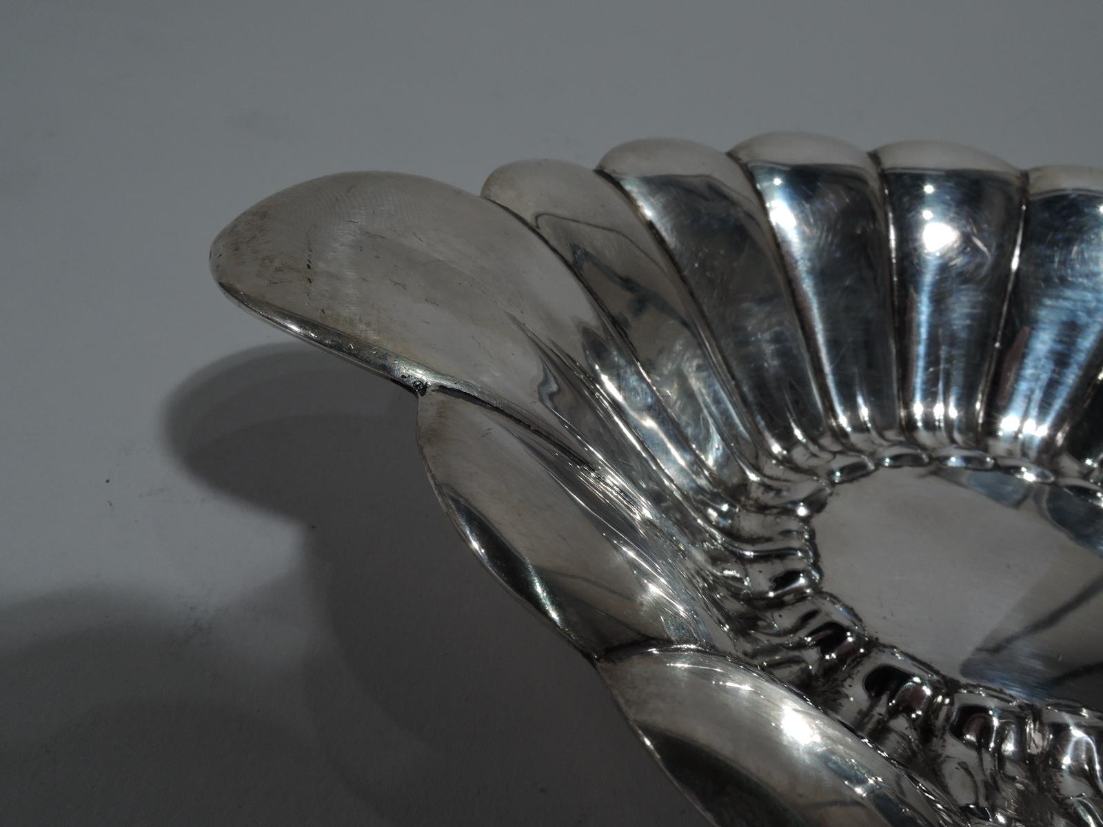 Mid-Century Modern sterling silver bowl. Made by Reed & Barton in Taunton, Mass., in 1947. Oval with scalloped petal sides and elongated ends. Fully marked including no. X323 and date symbol. Weight: 5 troy ounces.