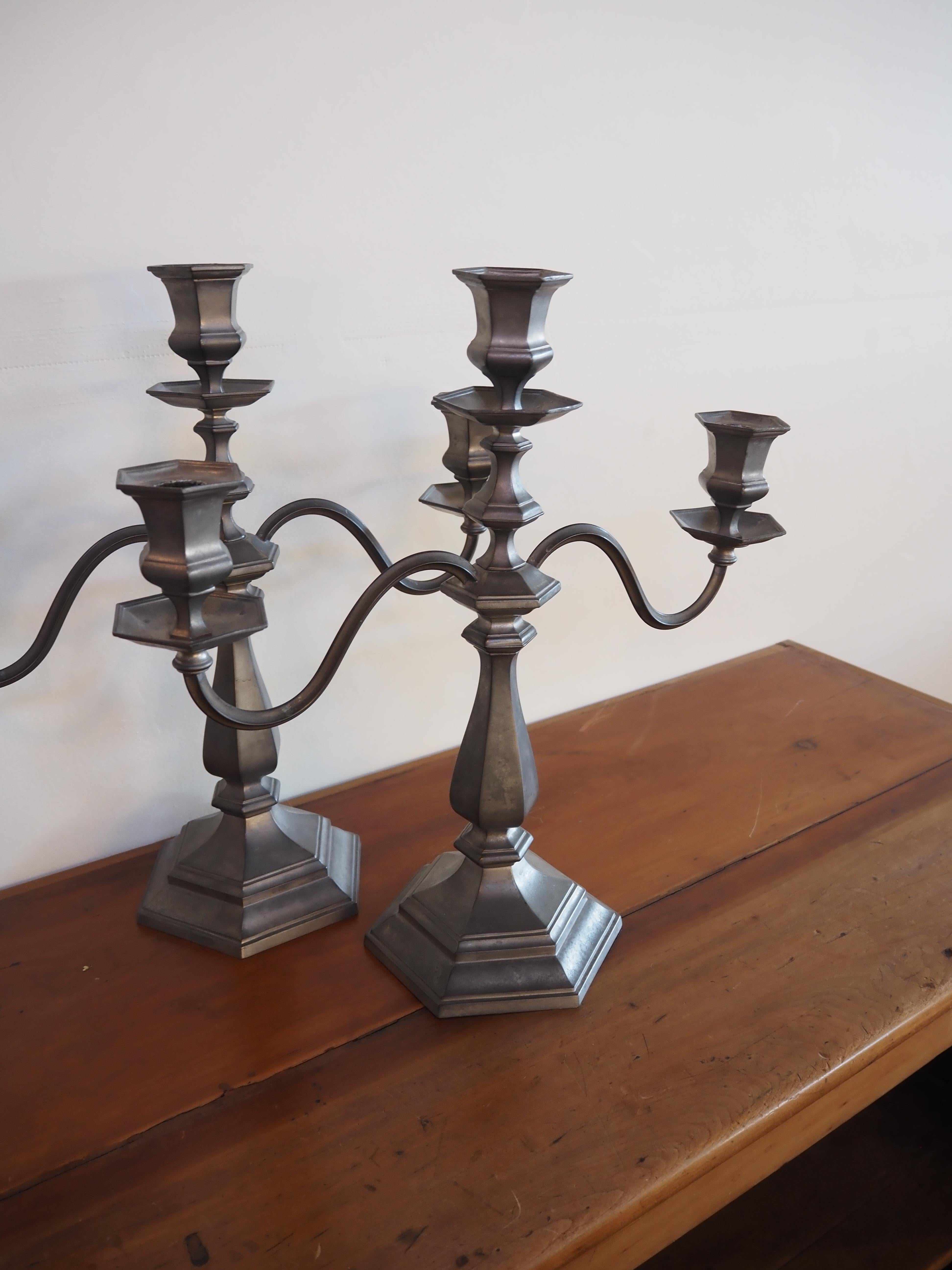 Simply beautiful pair of pewter candelabras designed and manufactured by Reed & Barton. Both pieces are stamped and numbered. 

Reed & Barton was a prominent American silversmith manufacturer based in the city of Taunton, Massachusetts, operating