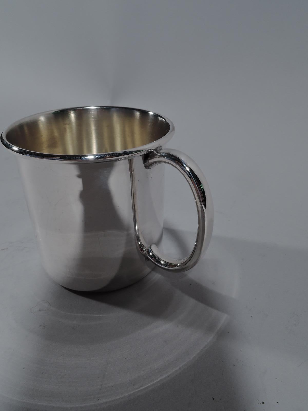 Plain and simple sterling silver baby cup. Made by Reed & Barton in Taunton, mass. Straight sides, C-scroll handle, and molded rim. The basic model that awaits engraving. Fully marked and numbered x 171. Weight: 2 troy ounces.