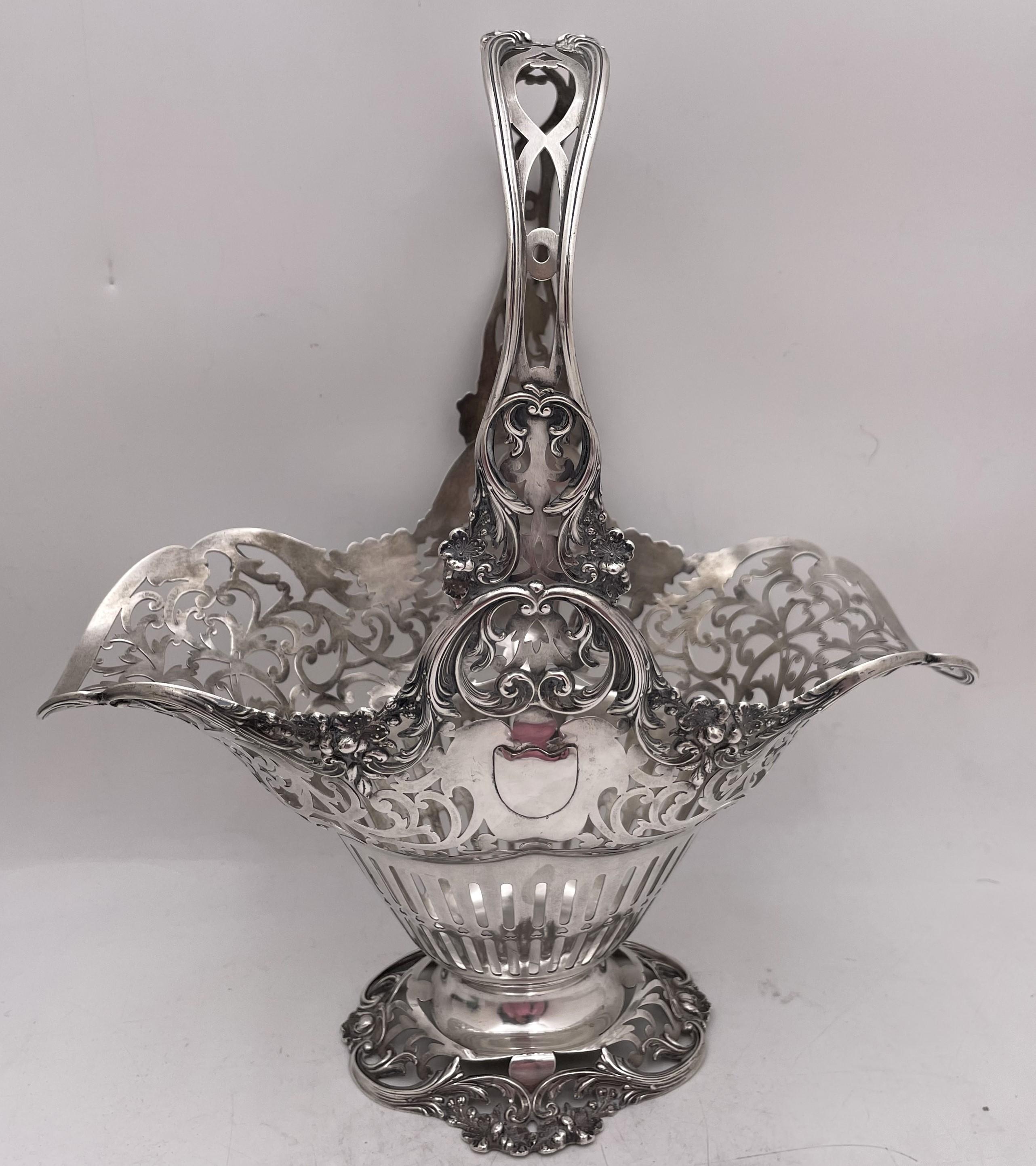 Reed & Barton sterling silver basket or centerpiece bowl, presumably from the early 20th century, in Art Nouveau style with pierced floral and geometric motifs. This elegant basket measures 13 3/4'' in height (including the handle; height of the