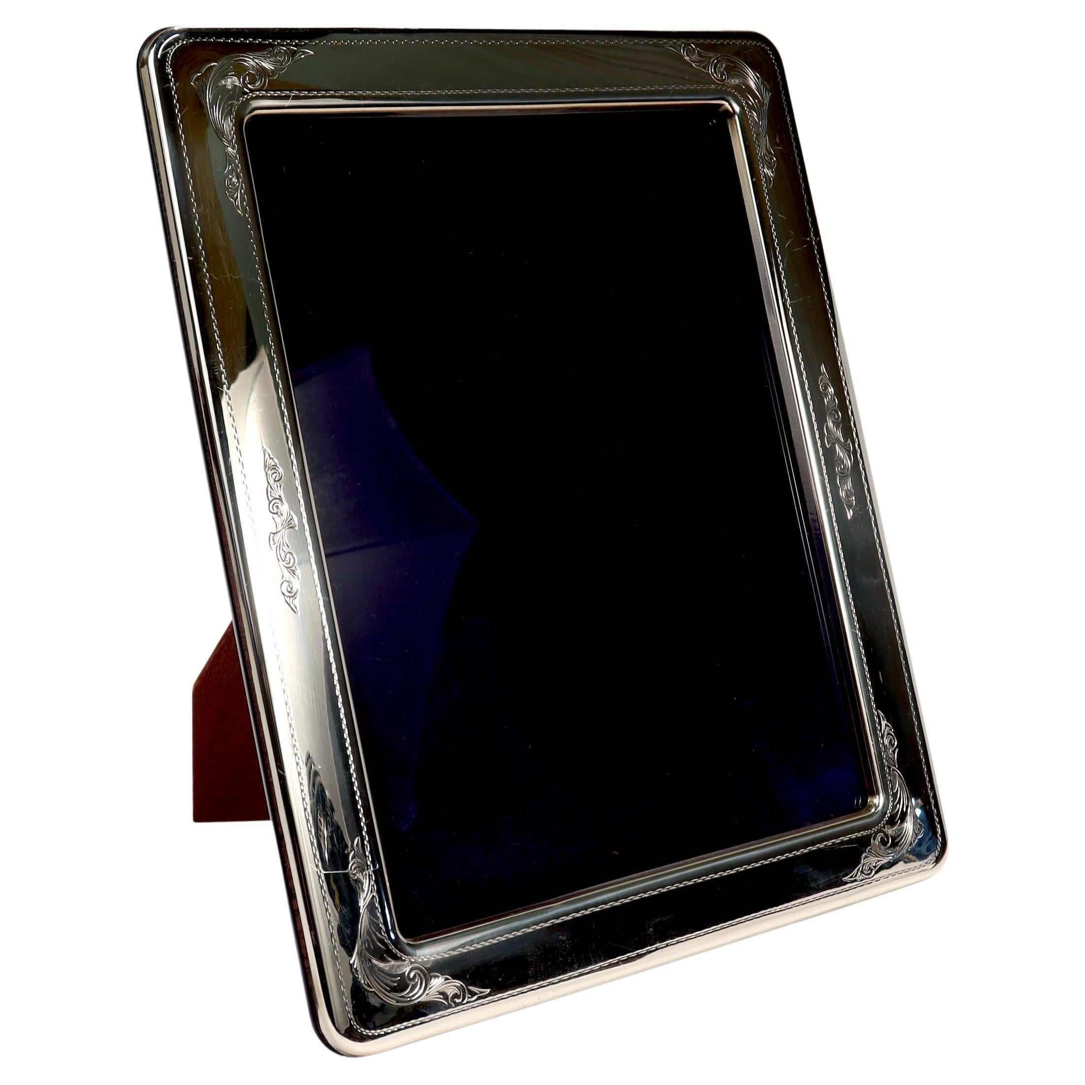 A fine sterling silver frame.

By Reed & Barton.

With rounded corners & etched decoration to the sides. 

Simply a wonderful frame!

Date:
Early 21st Century

Overall Condition:
It is in overall good, as-pictured, used estate condition.

Condition