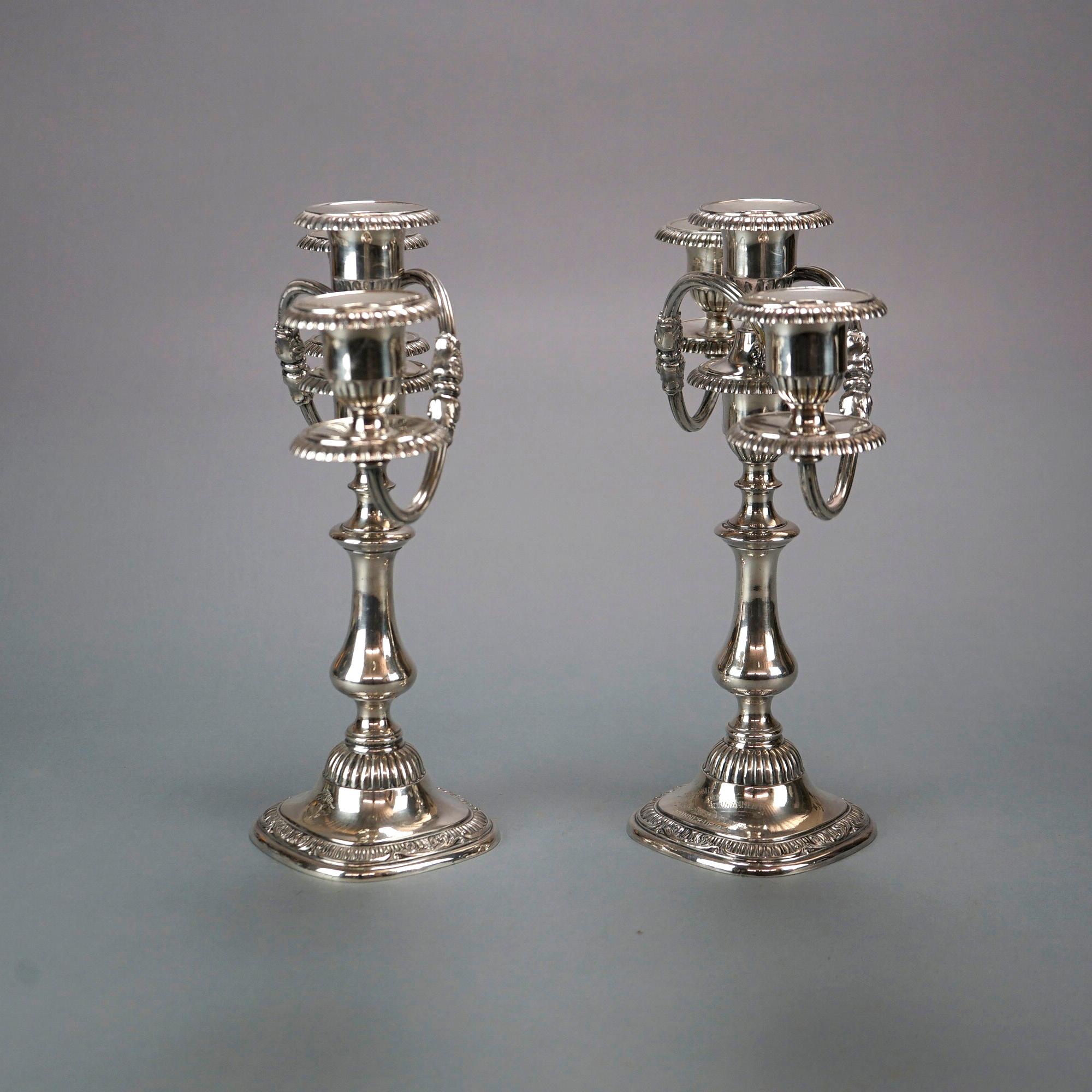 A pair of Reed and Barton silver plate candelabra offer three lights each raised on balustrade column with foliate embossed base having award inscription as photographed, c1950

Measures- 13''H x 13.5''W x 5''D

Catalogue Note: Ask about DISCOUNTED