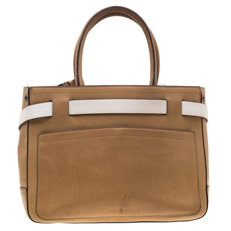 This Reed Krakoff Boxer tote features belt detailing at the front and is crafted from leather. It is equipped with dual rolled handles, buckles and a fabric-lined interior that has enough space to hold all your daily essentials.

Includes: Original