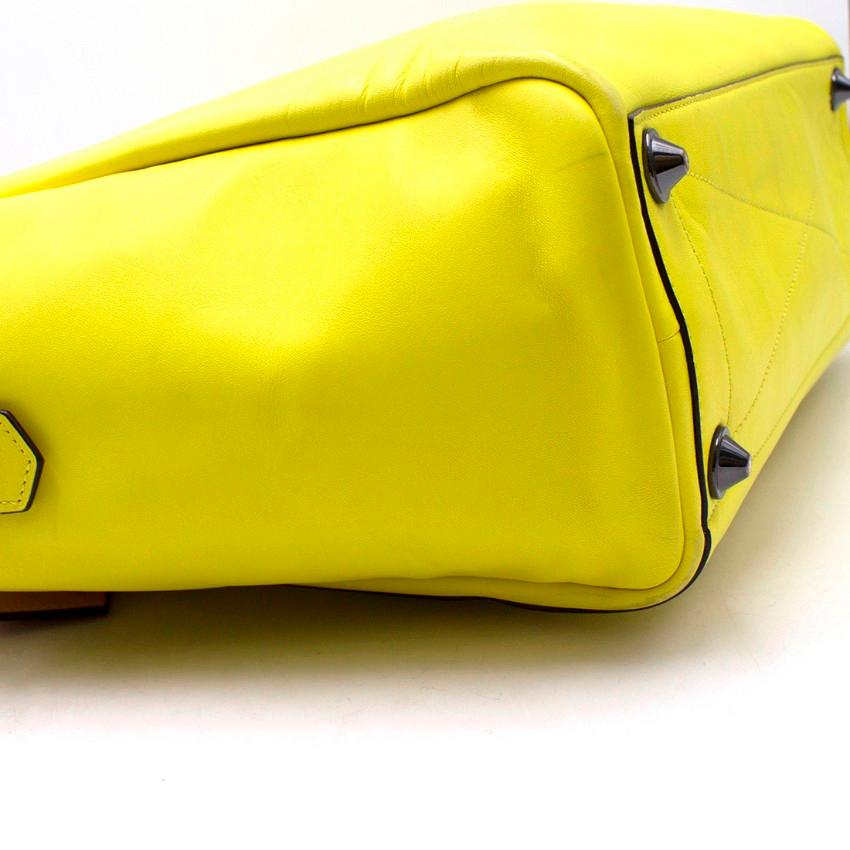 Reed Krakoff Fluorescent Yellow Handbag

- Maxi size
- Address tag
- Large external slip pockets on the back and the front, one with a removable white clutch with a zipped top and an external card slot and branding embossed
- Double shoulder