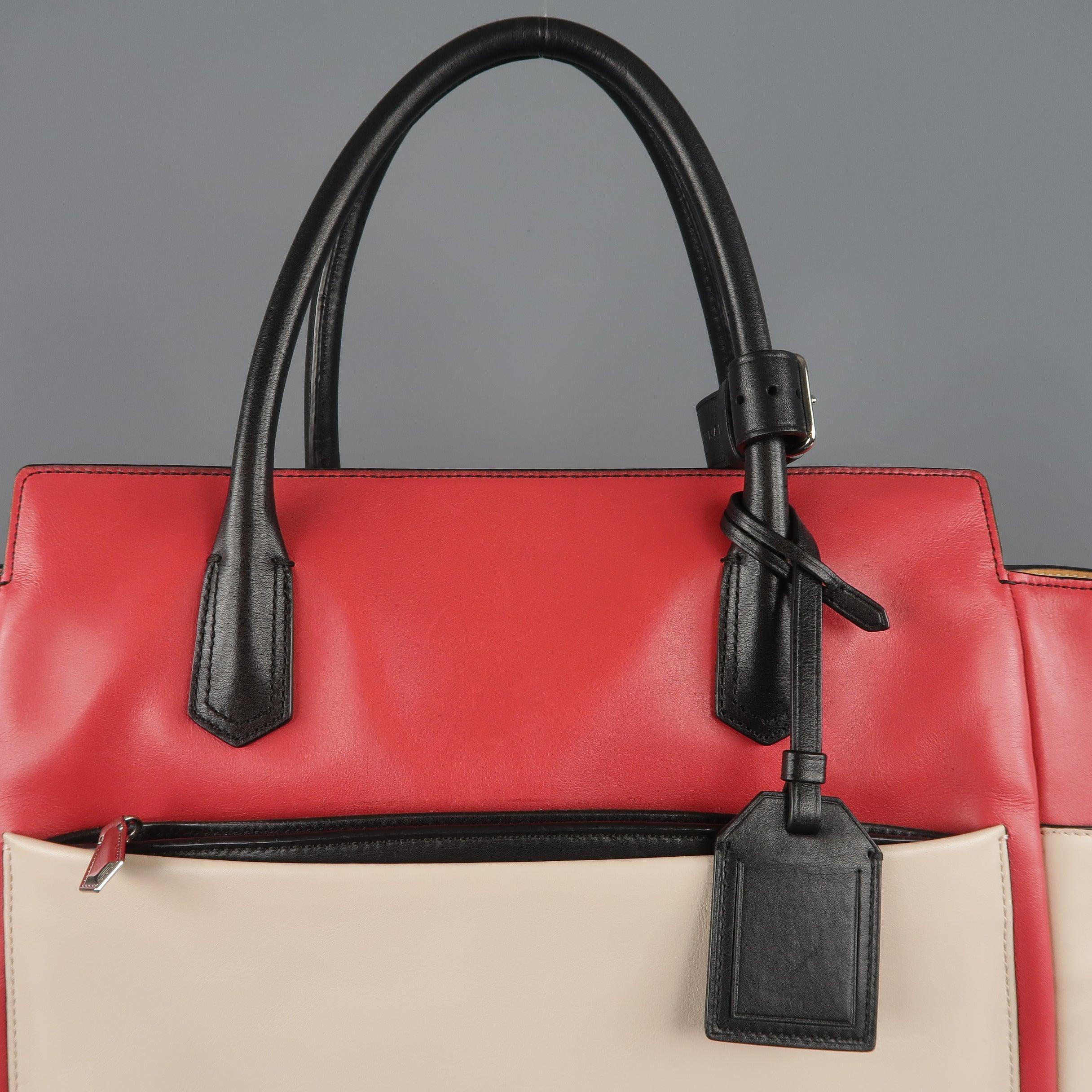 REED KRAKOFF tote bag comes in light pink leather with a light red top panel, black covered double top handles and piping, multi-pocket sides and back, and canvas interior. Wear throughout. Good Pre-Owned Condition. 

Measurements: 
  Length: 17