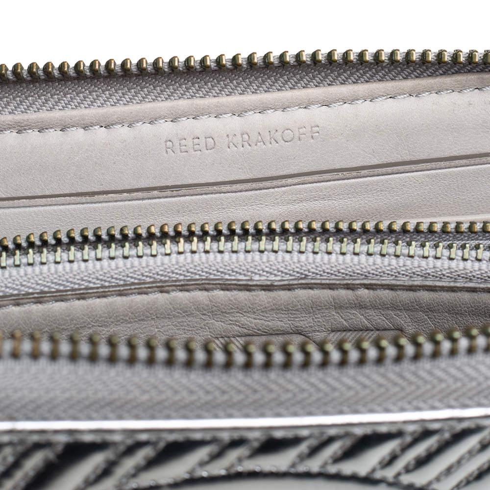 Functional and stylish Reed Krakoffs collections capture the effortless nonchalant finesse of the modern woman. Crafted from leather in a silver hue this chic wallet features a compartmentalized interior with a neatly stitched exterior. The sleek