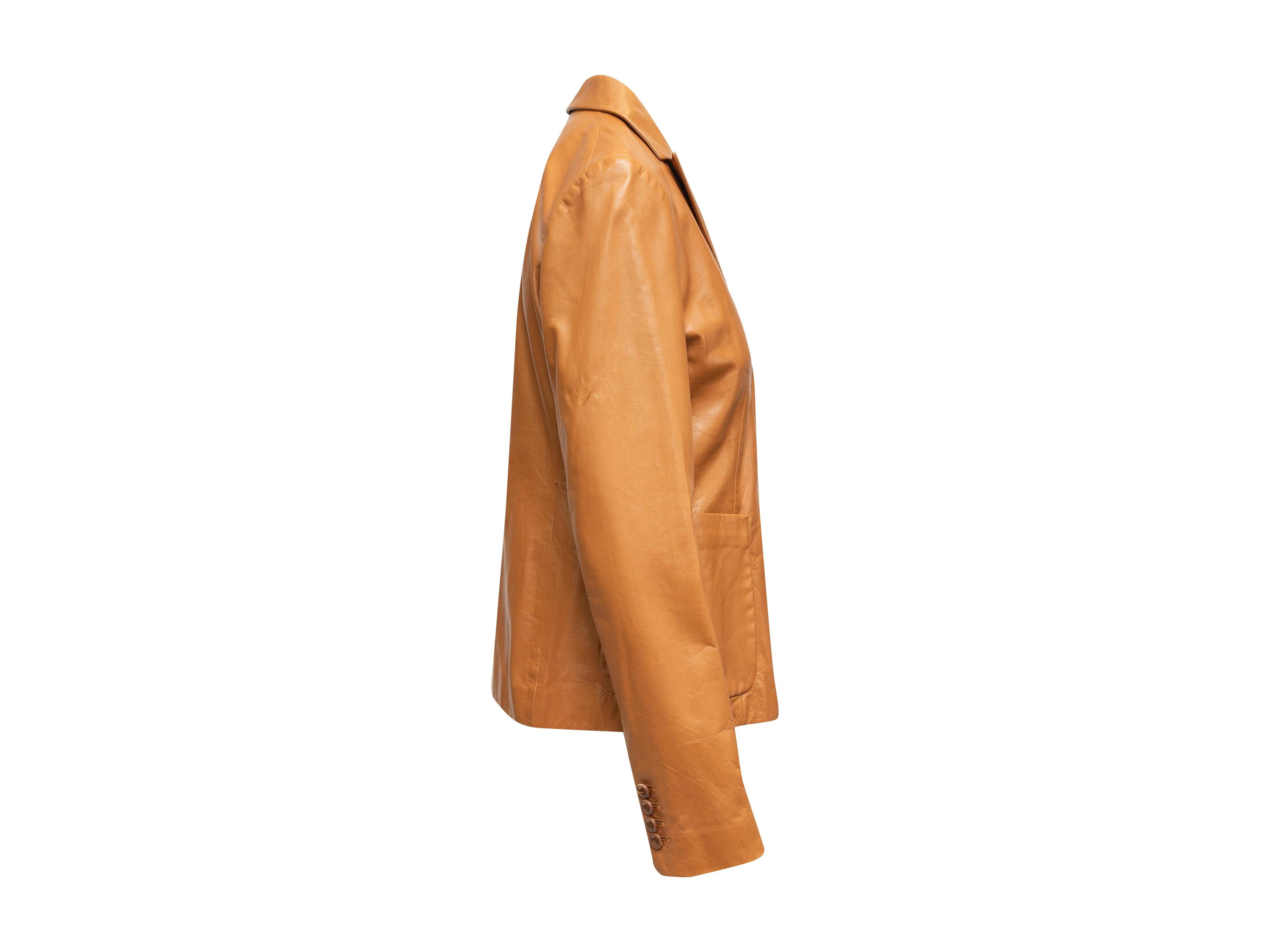 Product details: Tan leather double-breasted blazer by Reed Krakoff. Peaked lapels. Welt pocket at bust. Dual patch pockets at hips. Concealed closures at front. 36