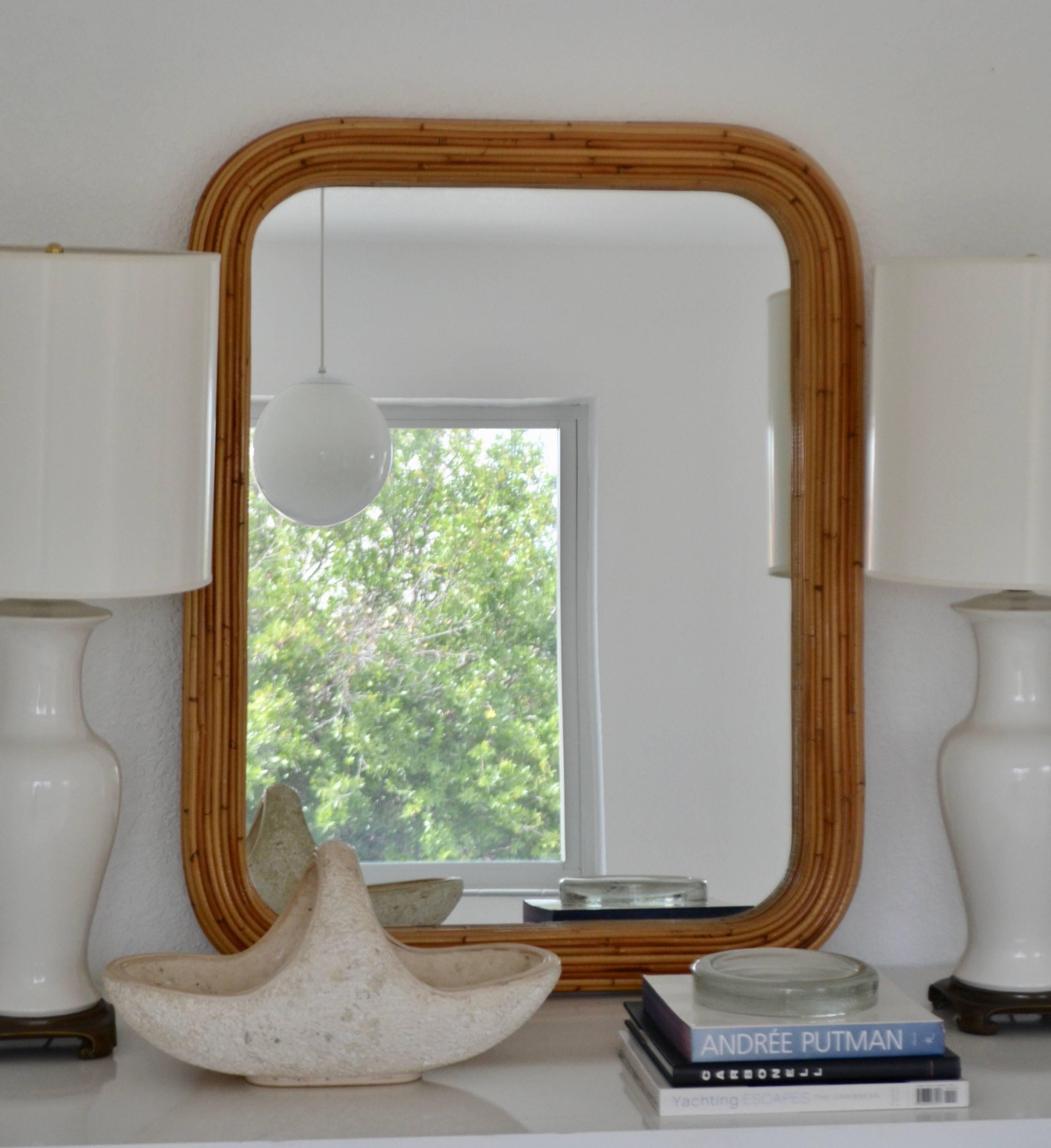 Glamorous midcentury reeded bamboo rectangular form mirror with rounded corners, circa 1960s-1970s. This impactful sculptural mirror measures 43