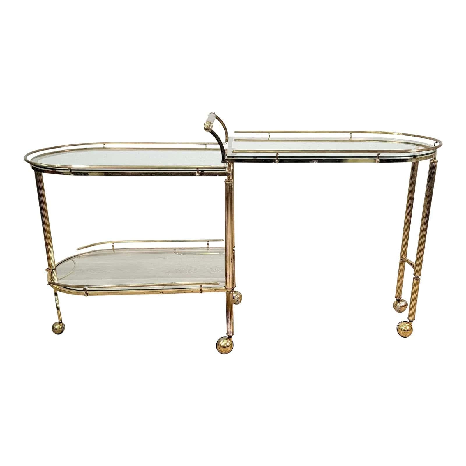 Fabulous solid brass and glass folding bar cart. The handcrafted cart can be extended to provide more space while entertaining. It has five legs with smoothly gliding wheels. The middle leg locks into place with a hook or unlocks to move the bar a