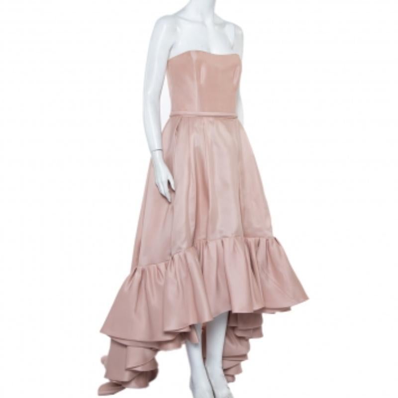 Effortless and exuding grace, this Reem Acra creation will make sure your special evening is spent well. Crafted from luxurious silk, it carries a beautiful shade of pink that adds to the soft silhouette of the strapless gown. The straight bodice